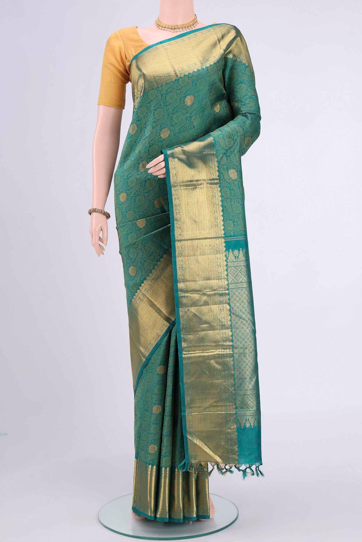 Sea Green Kanchipuram Saree with Jacquard With Zari Butta on the body and Zari Border displayed on a mannequin