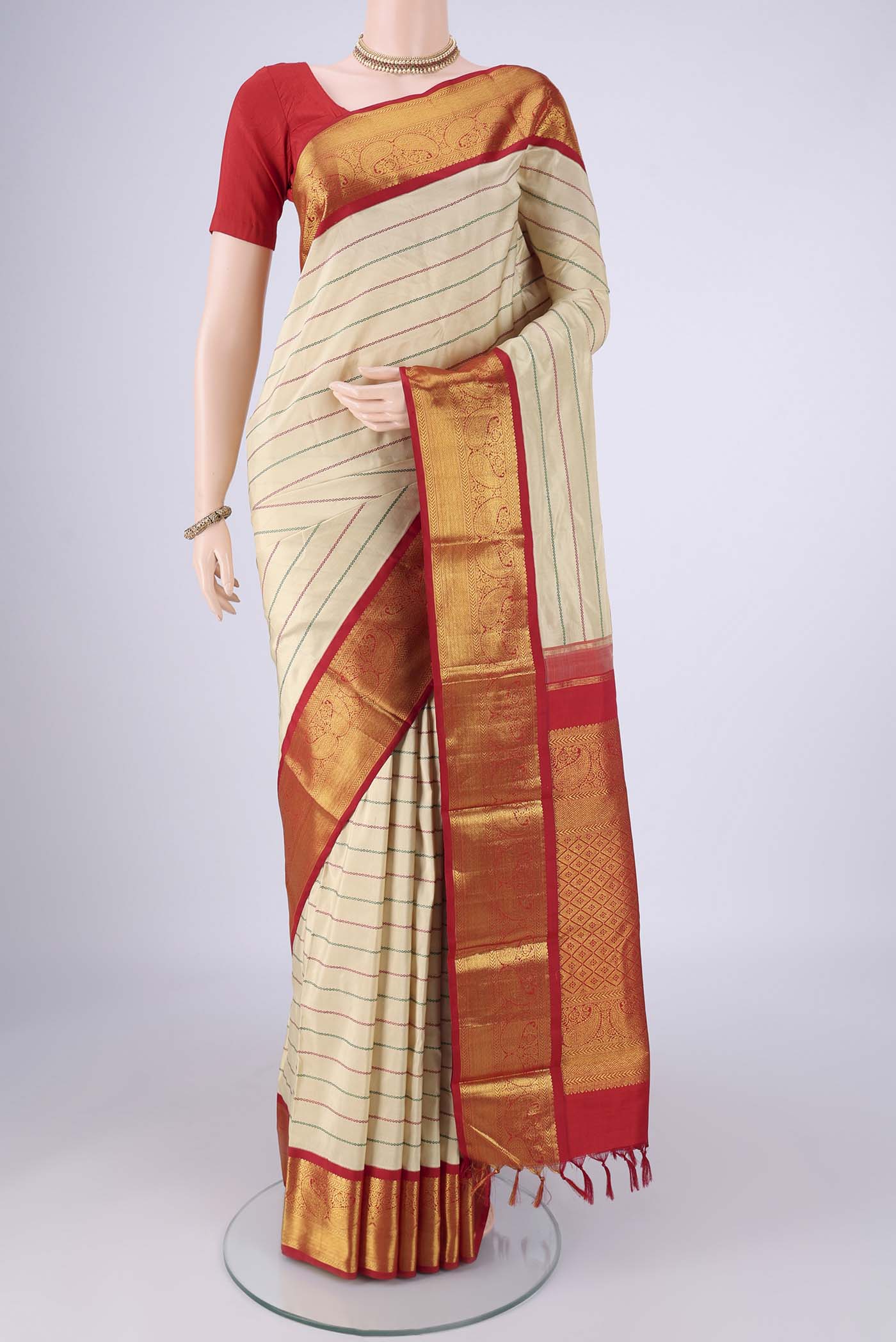 Beige Kanjivaram Silk Saree with Veldhari on the body and Zari Border.  displayed on a mannequin