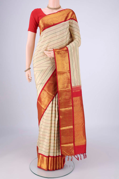 Beige Kanjivaram Silk Saree with Veldhari on the body and Zari Border.  displayed on a mannequin