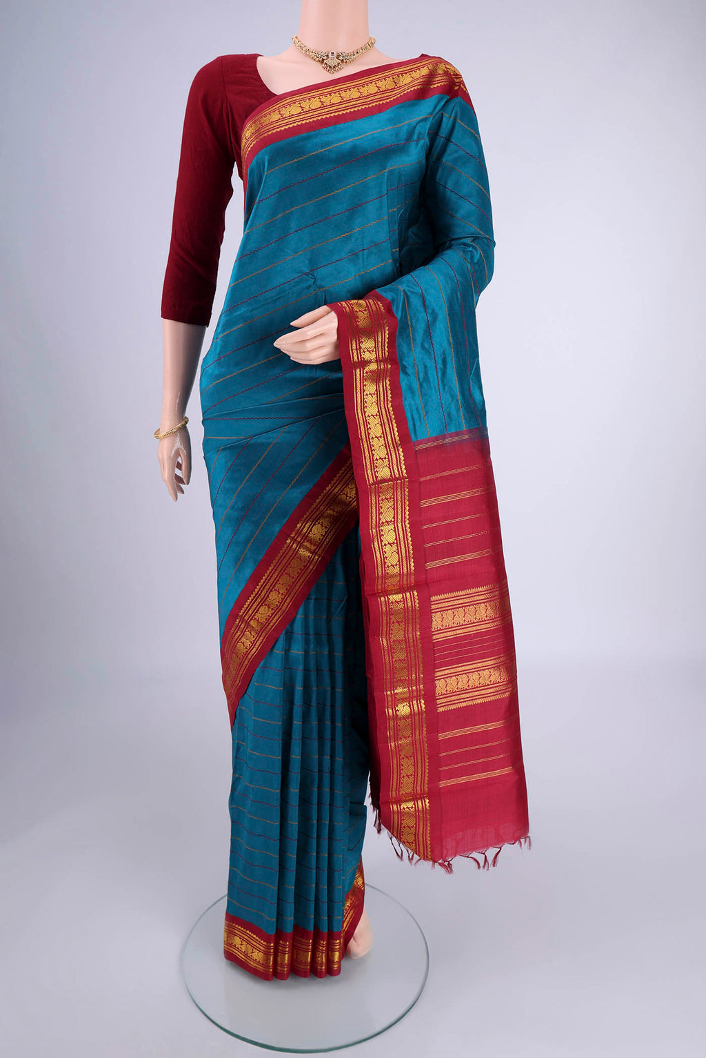 Blue Kanchipuram Silk Saree with Veldhari on the body and Zari Border.  displayed on a mannequin