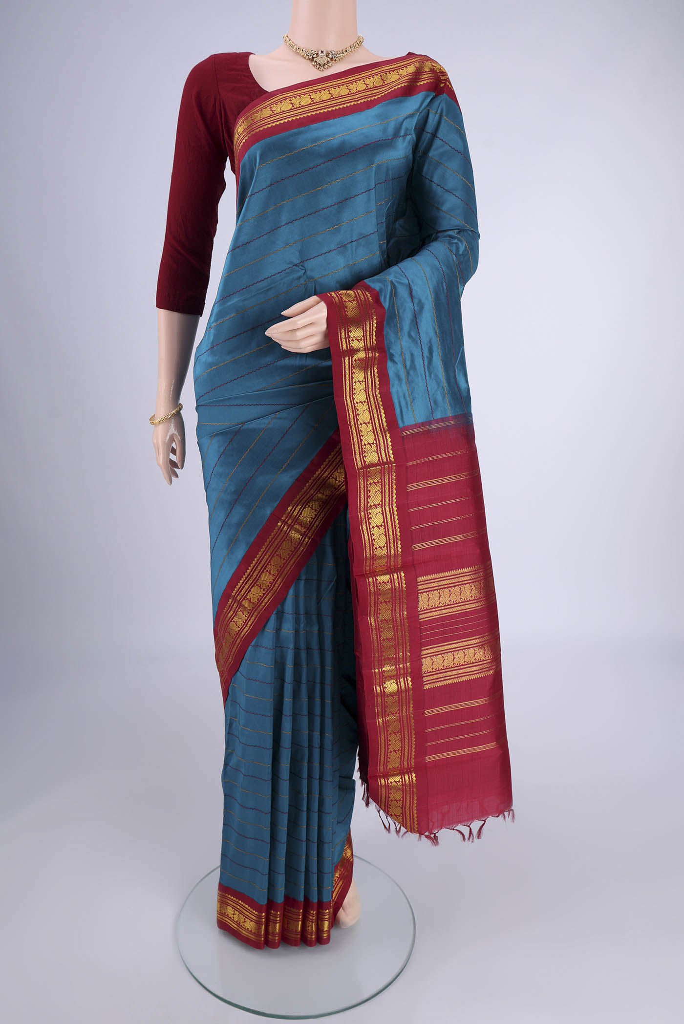 Blue Kanchipuram Silk Saree with Veldhari on the body and Zari Border.  displayed on a mannequin