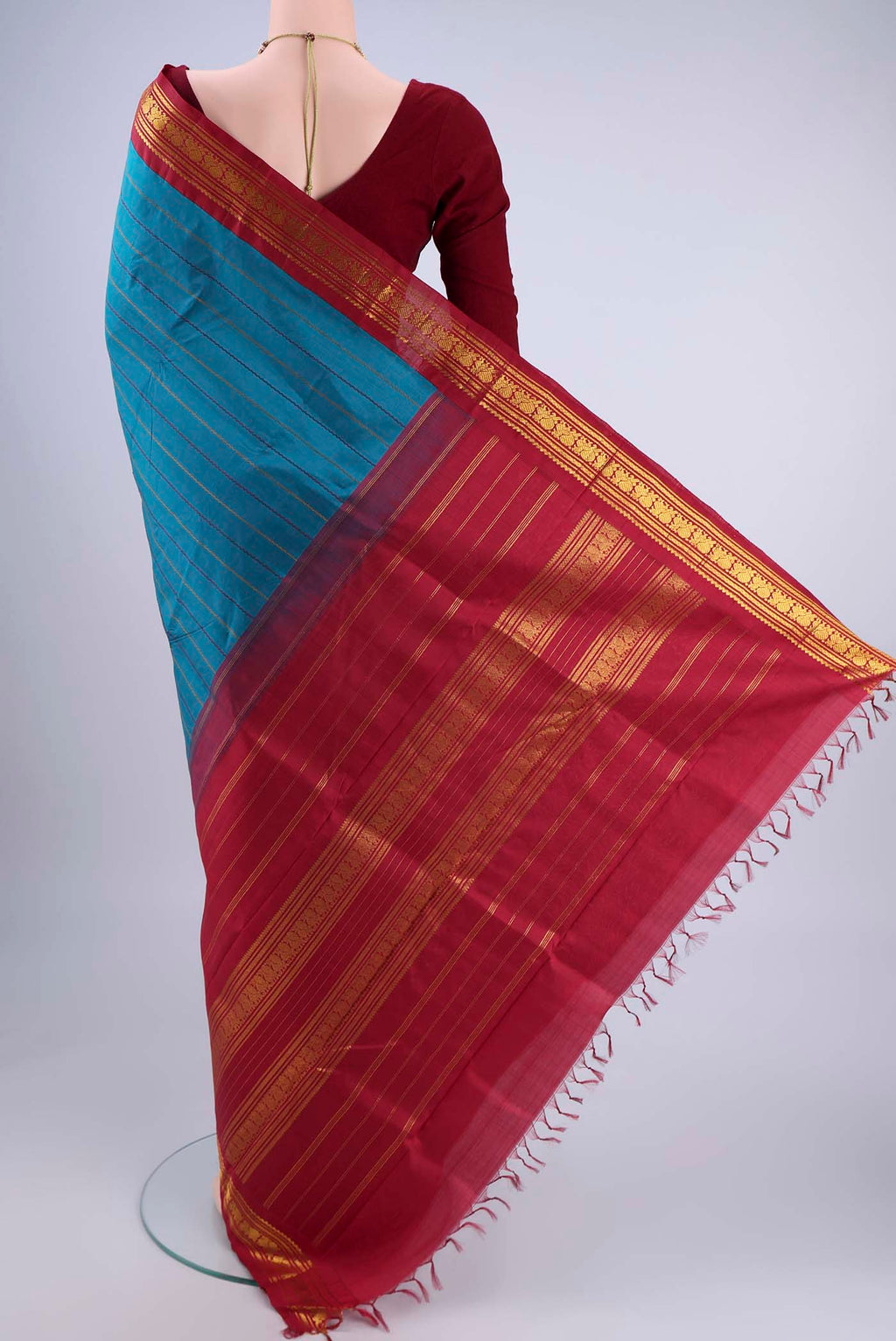 Flat view of Blue Kanchipuram Silk Saree with Veldhari on the body and Zari Border. 