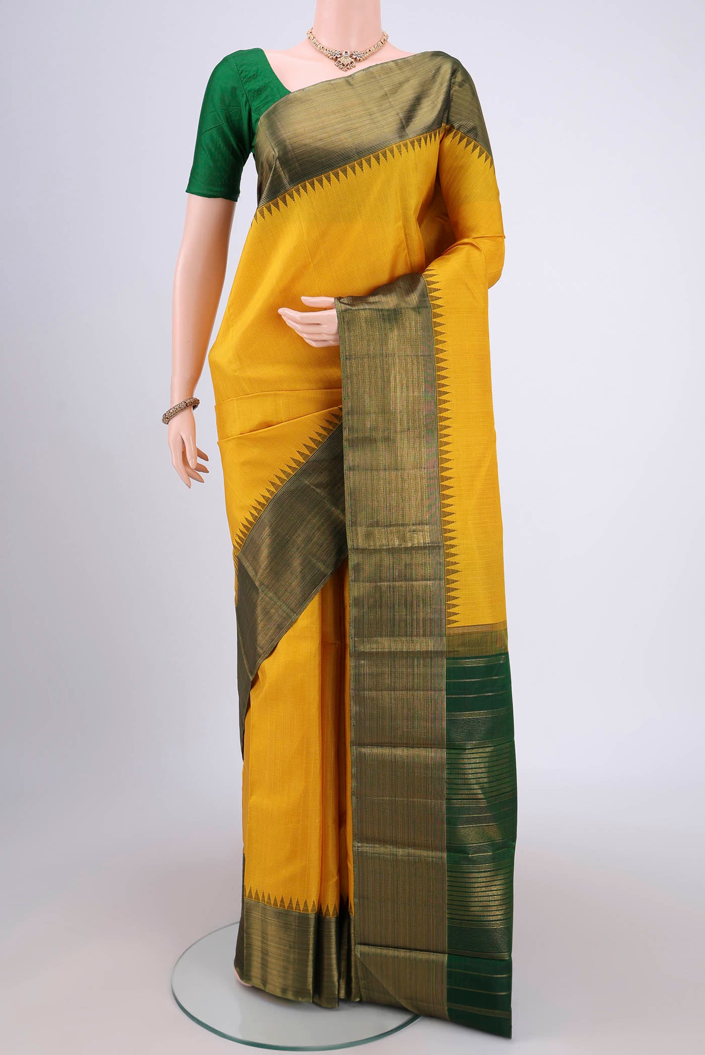 Yellow Kanjivaram Silk Saree with Stripes on the body and Attached Border.  displayed on a mannequin