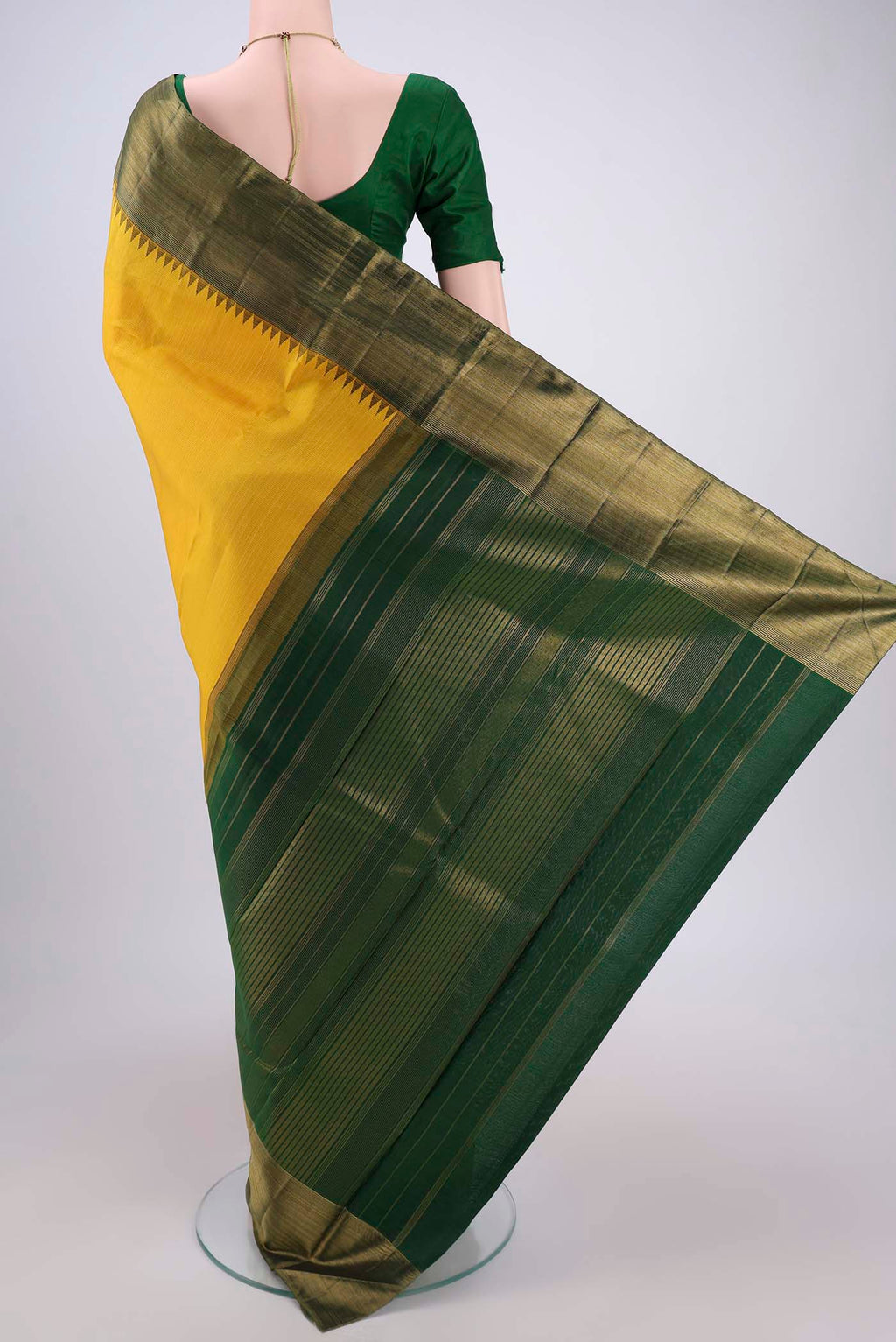 Flat view of Yellow Kanjivaram Silk Saree with Stripes on the body and Attached Border. 