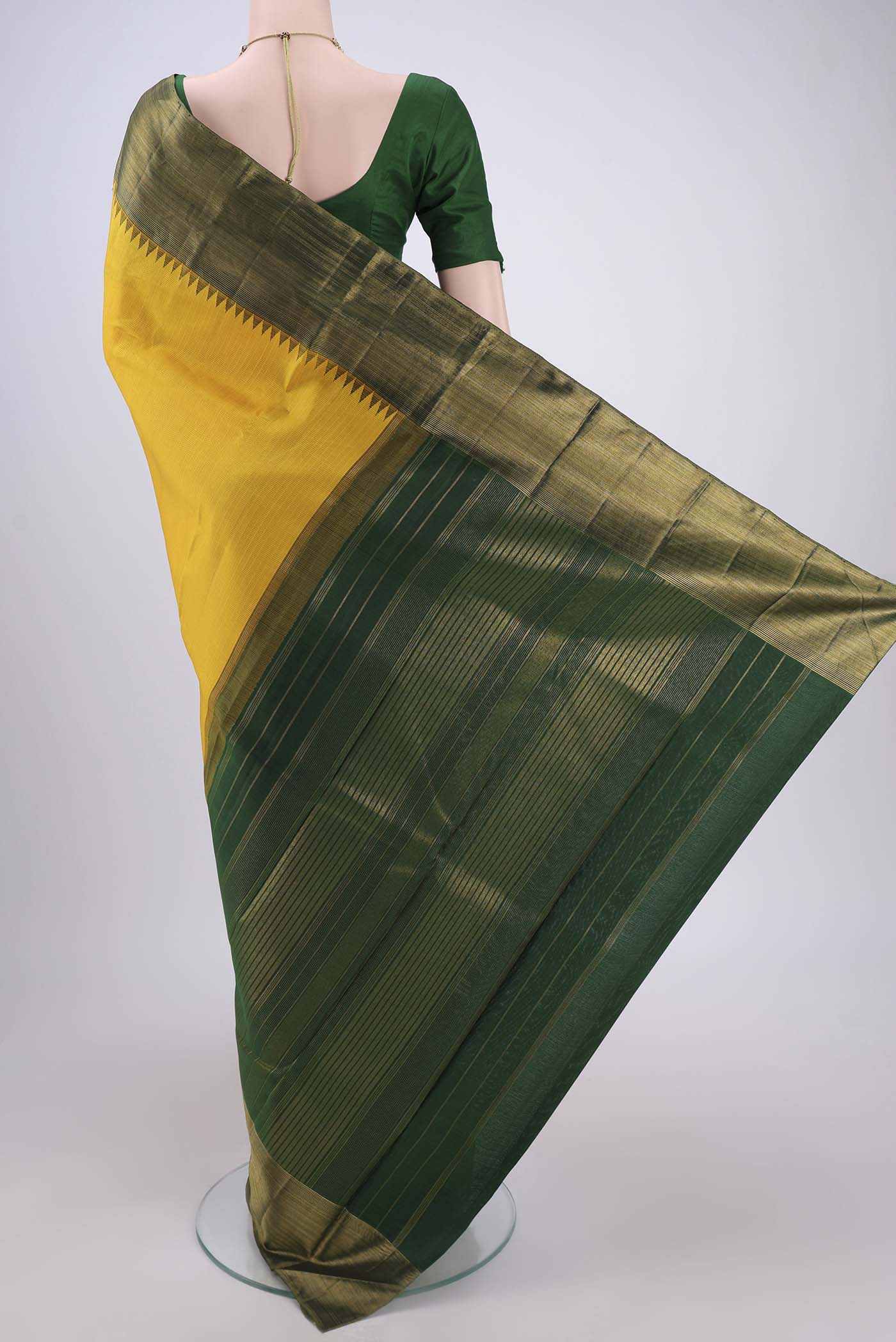Flat view of Yellow Kanjivaram Silk Saree with Stripes on the body and Attached Border. 