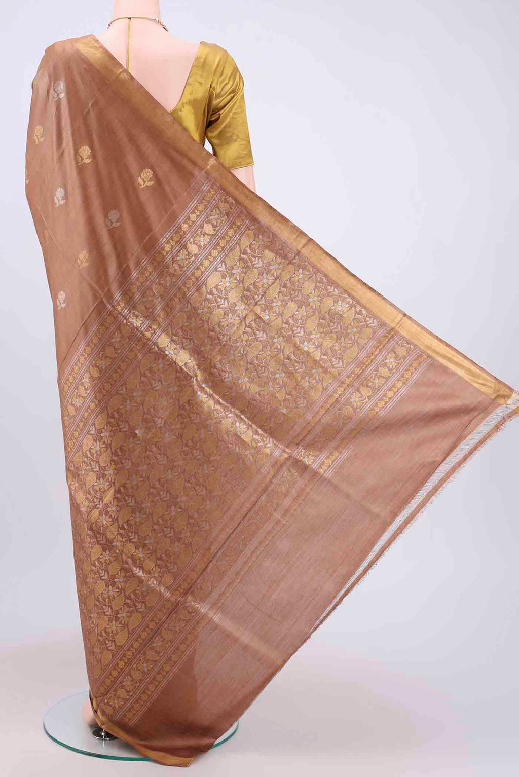 Flat view of Brown Tussar Silk Saree with Zari Butta on the body and Zari Border. 