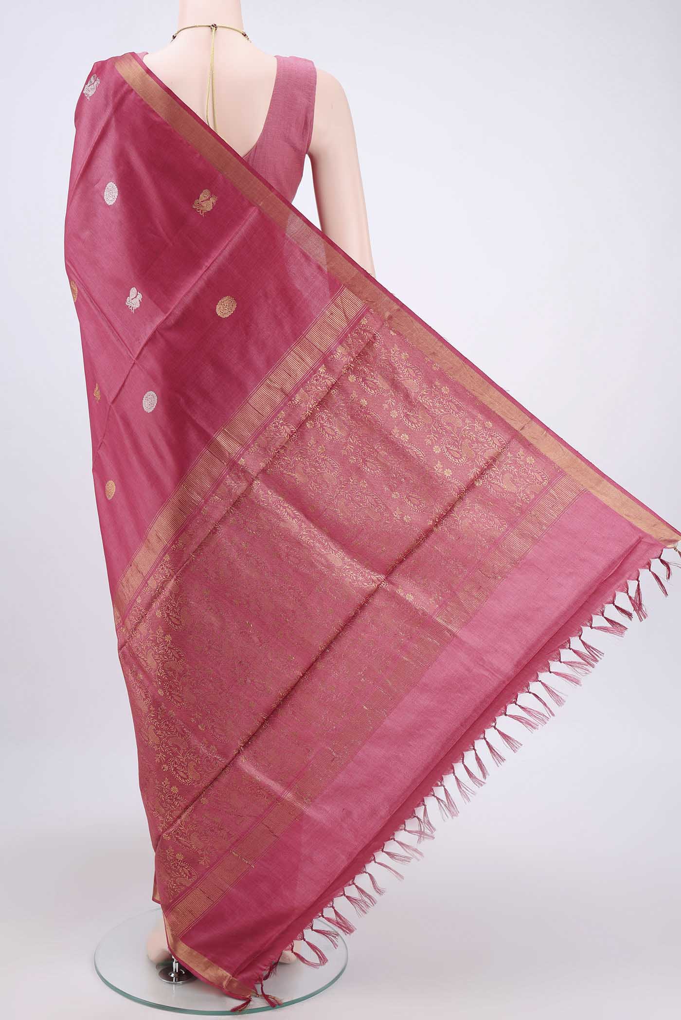 Flat view of Dark Pink Tussar Silk Saree with Zari Butta on the body and Zari Border. 