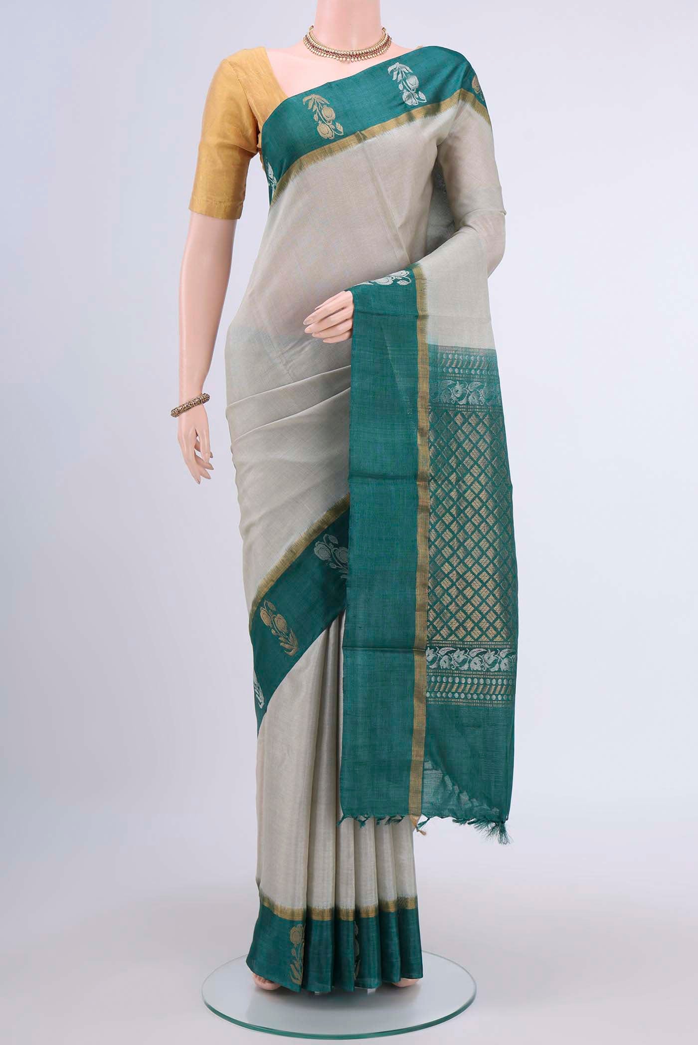 Beige Tussar Silk Saree with Plain Body and Zari Border displayed on a mannequin