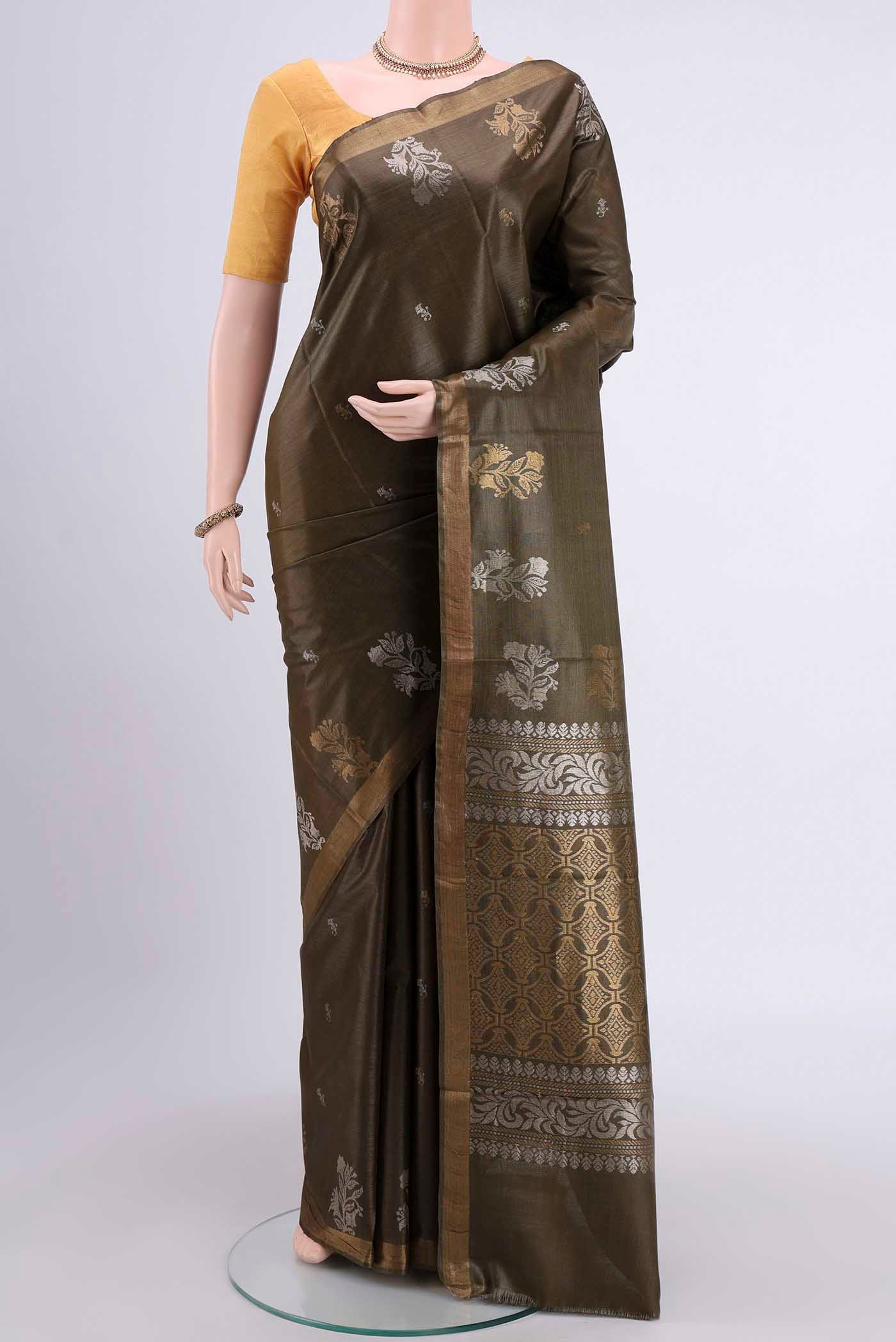 Mehandi Green Tussar Silk Saree with Zari Butta on the body and Zari Border displayed on a mannequin