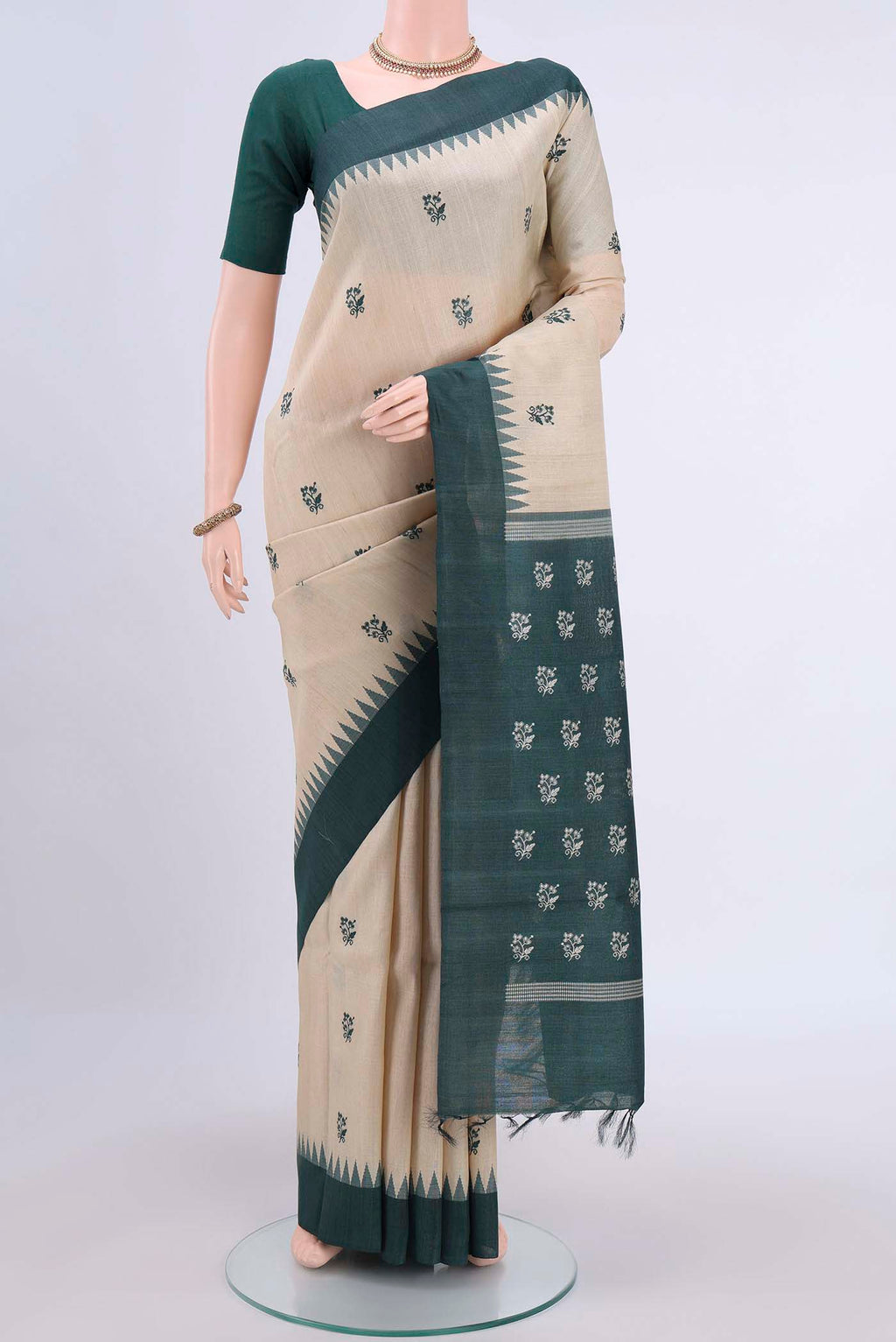 Beige Tussar Silk Saree with Embroidery on the body and Temple Border displayed on a mannequin