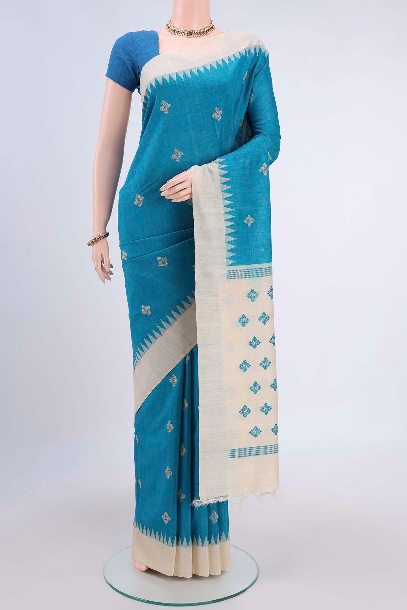 Blue Tussar Silk Saree with Thread Butta on the body and Zari Border displayed on a mannequin