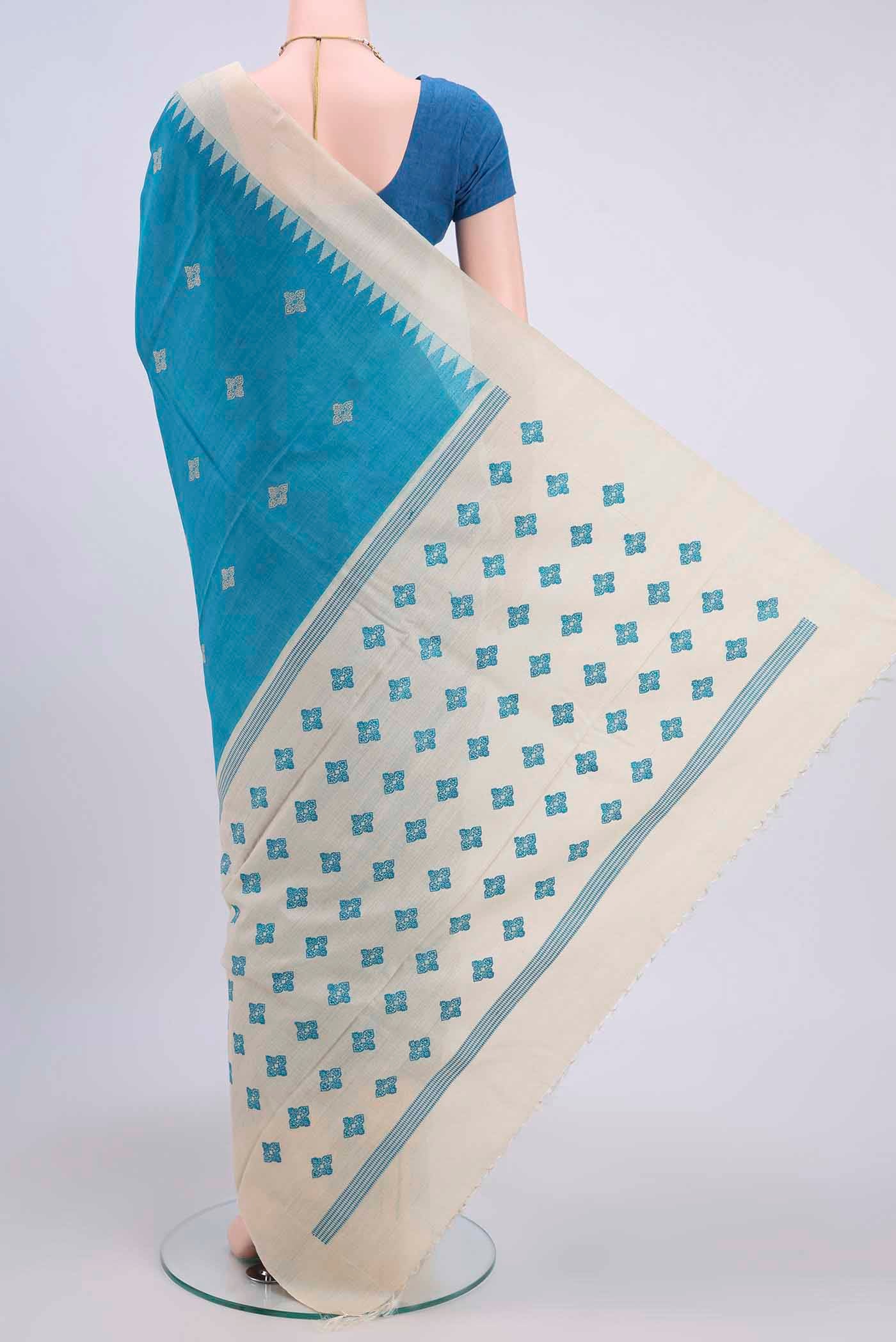 Flat view of Blue Tussar Silk Saree with Thread Butta on the body and Zari Border