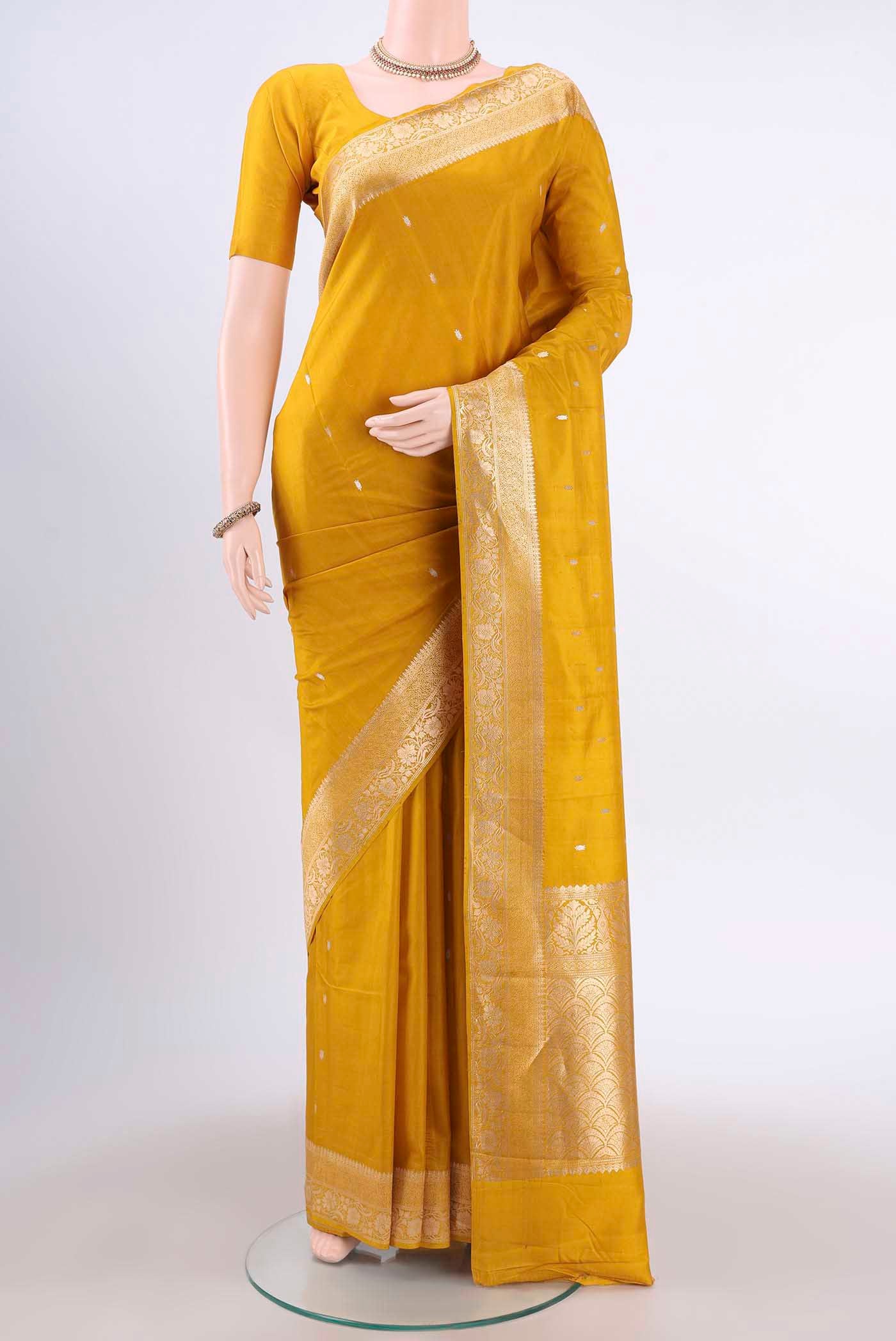 Yellow Banarasi Katan Silk Saree with Zari Butta on the body and Zari Border displayed on a mannequin