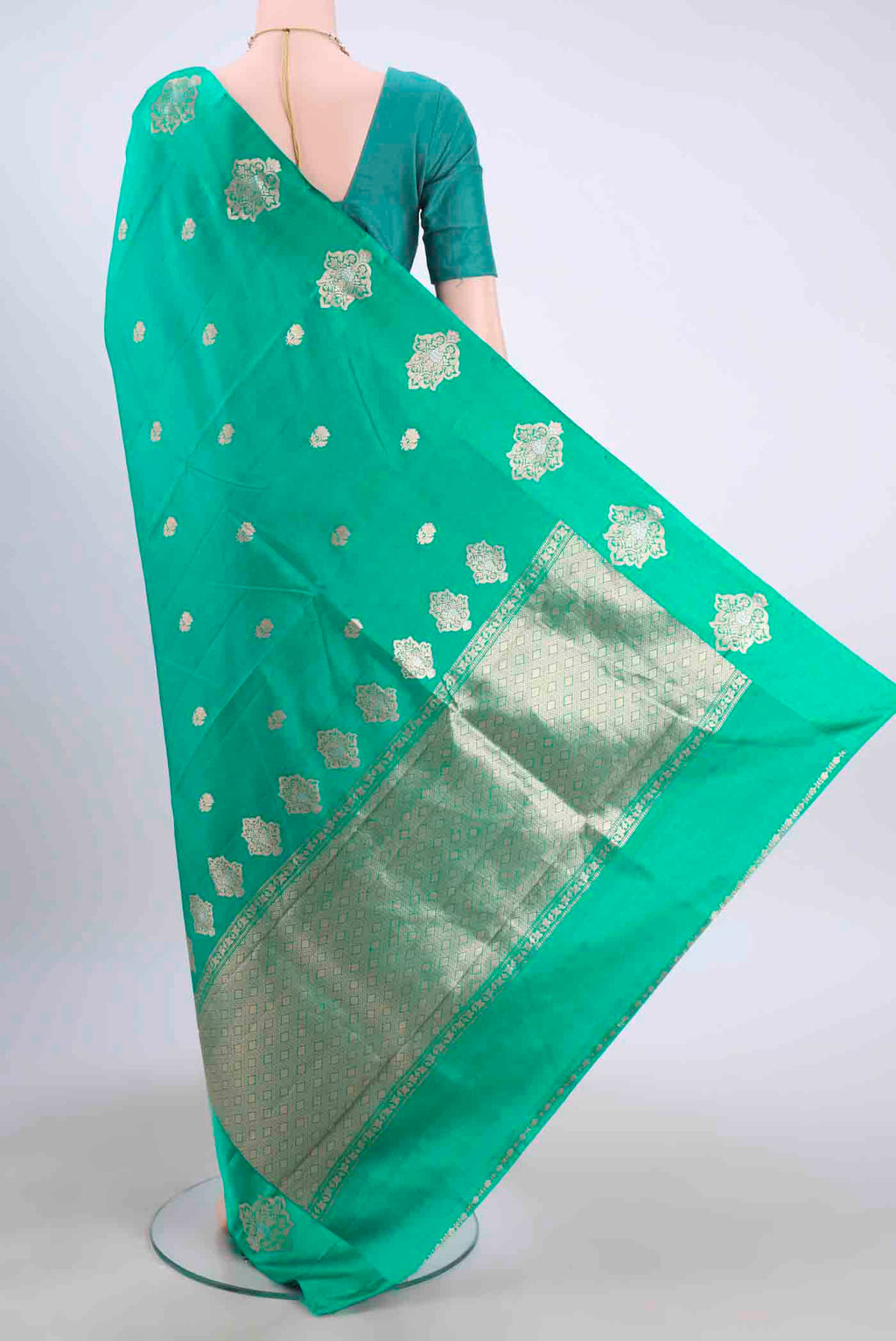 Flat view of Sea Green Banarasi Katan Silk Saree with Zari Butta on the body and Satin Border