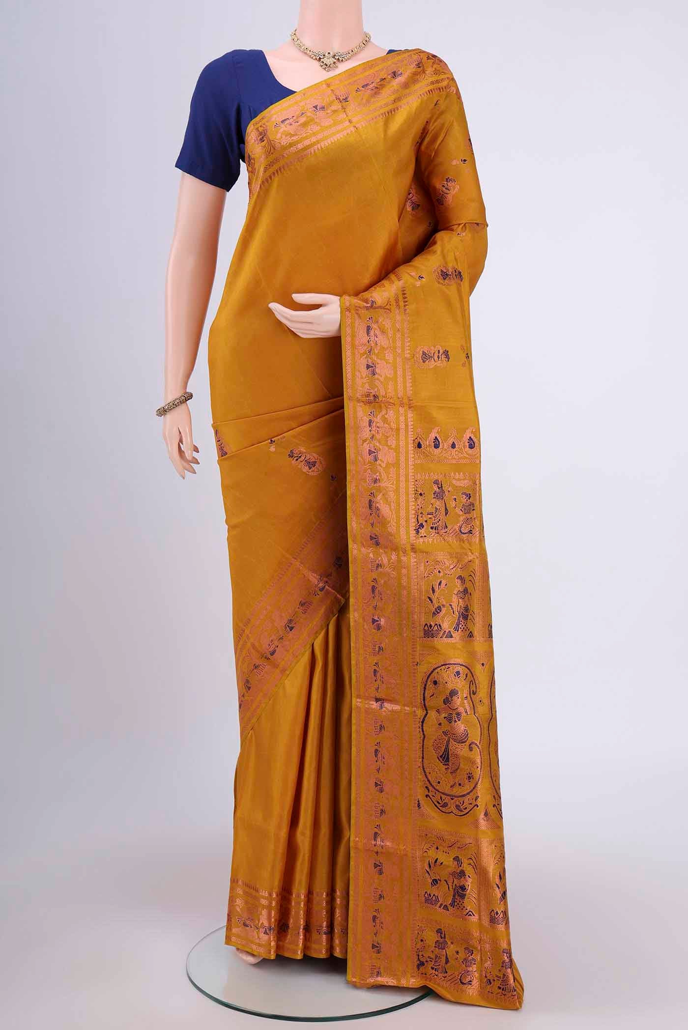 Mustard Dual Tone Baluchari Silk Saree with Zari And Thread Butta on the body and Zari Border.  displayed on a mannequin