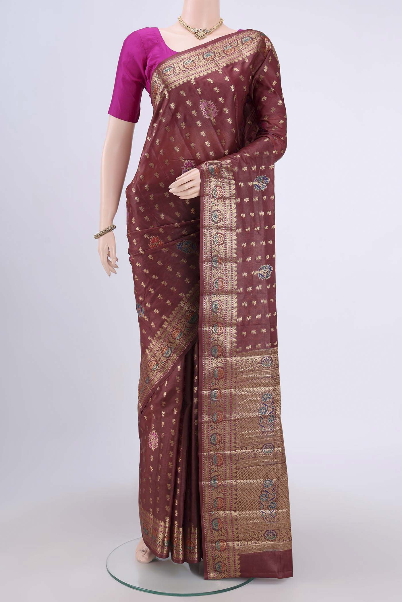 Brown Banarasi Tussar Silk Saree with Zari Butta on the body and Zari Border.  displayed on a mannequin
