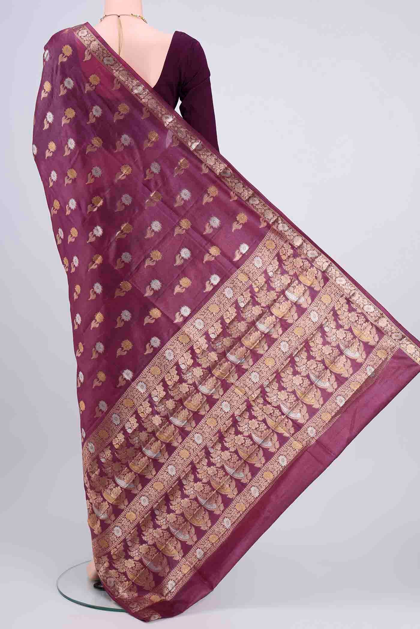 Flat view of Dark Mauve Banarasi Tussar Silk Saree with Zari Butta on the body and Zari Border