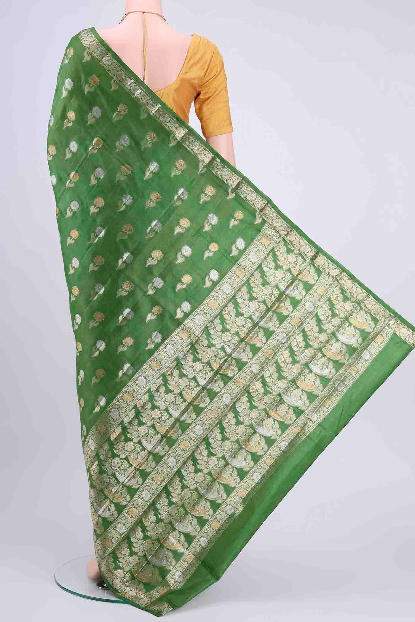 Flat view of Green Banarasi Tussar Silk Saree with Zari Butta on the body and Zari Border