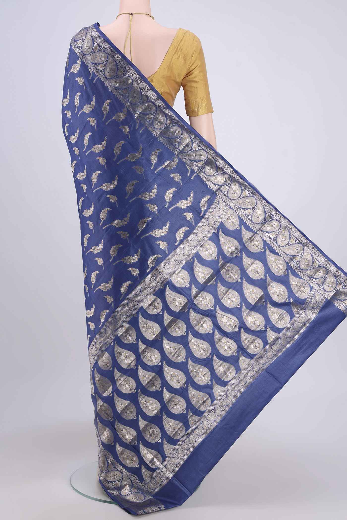 Flat view of Royal Blue Banarasi Tussar Silk Saree with Zari Butta on the body and Zari Border. 