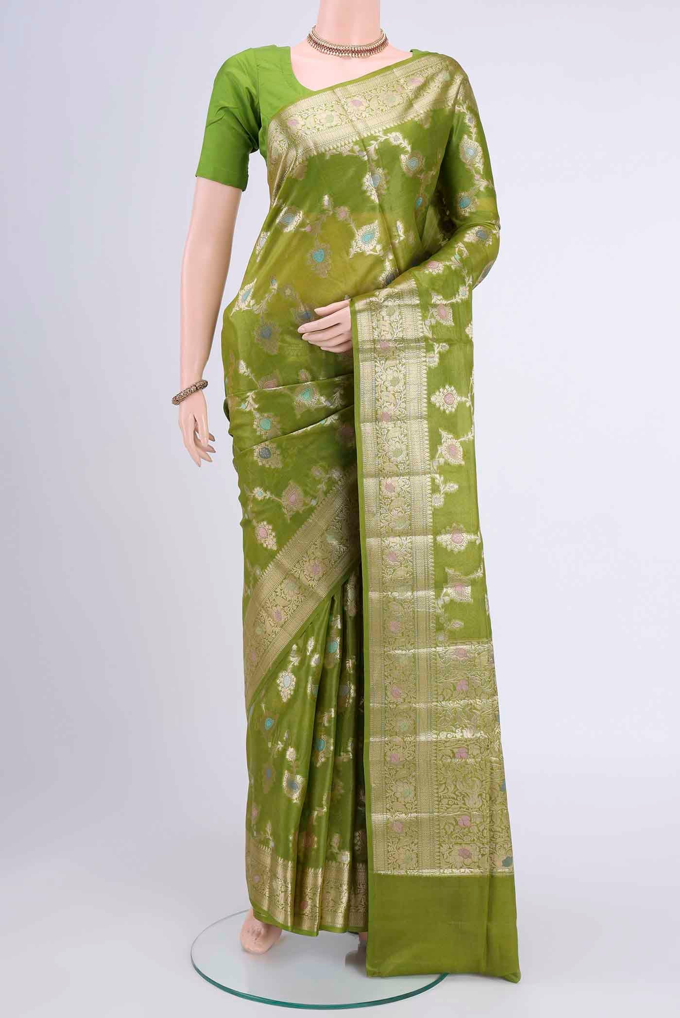 Light Green Banarasi Tussar Silk Saree with Zari Butta on the body and Zari Border displayed on a mannequin