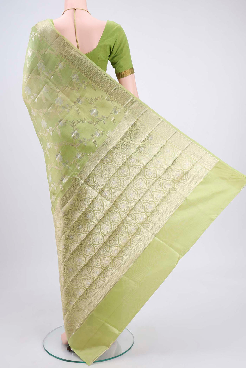 Flat view of Light Green Banarasi Raw Silk Saree with Zari Butta on the body and Zari Border. 