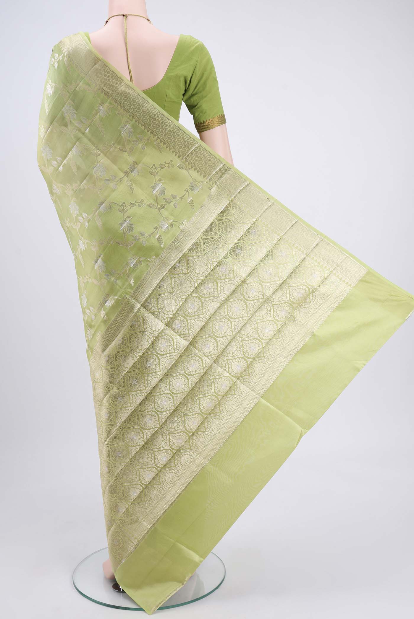 Flat view of Light Green Banarasi Raw Silk Saree with Zari Butta on the body and Zari Border. 