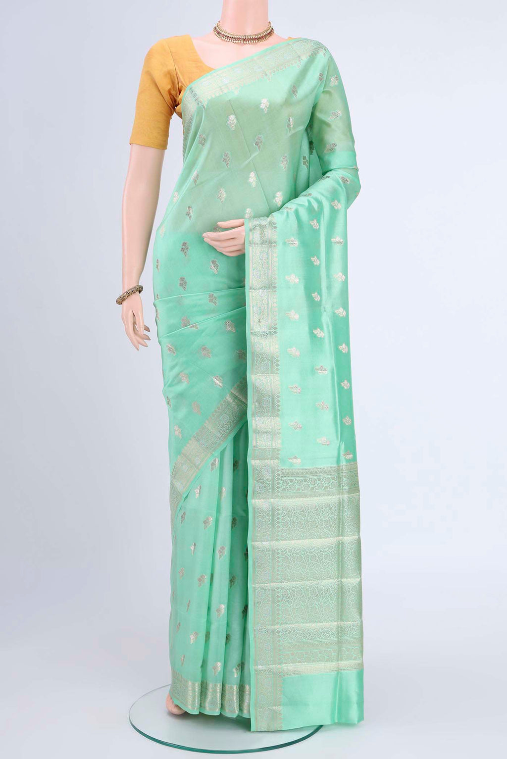 Mint Green Banarasi Raw Silk Saree with Zari Butta on the body and Zari Border displayed on a mannequin