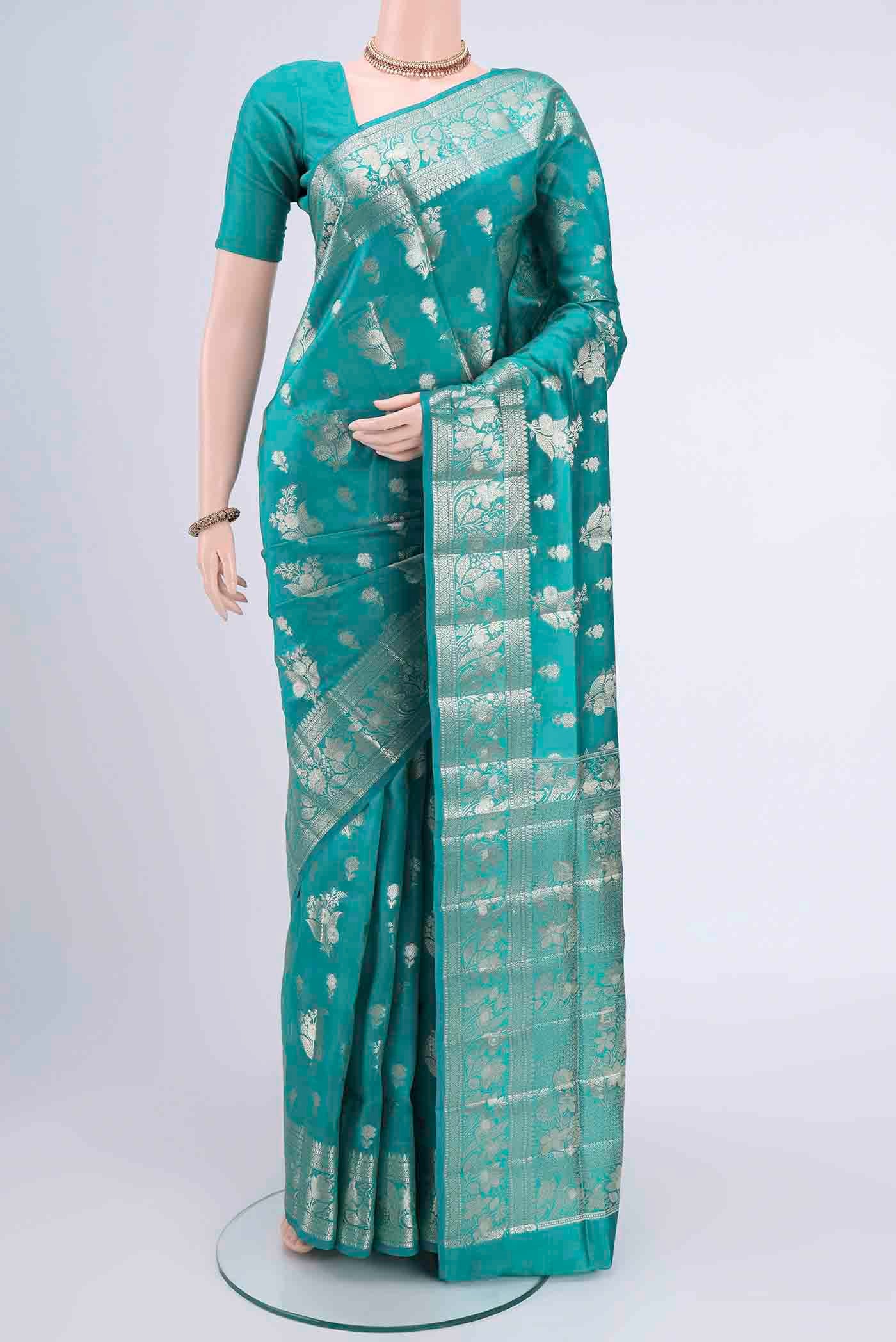 Turquoise Banarasi Raw Silk Saree with Zari Butta on the body and Zari Border displayed on a mannequin
