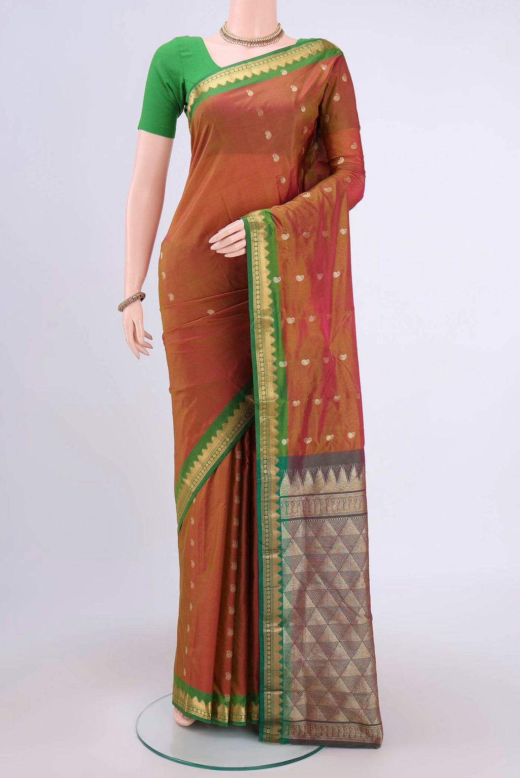 Brick Orange Dual Tone Blended Bangalore Silk Saree with Zari Butta on the body and Temple Border.  displayed on a mannequin
