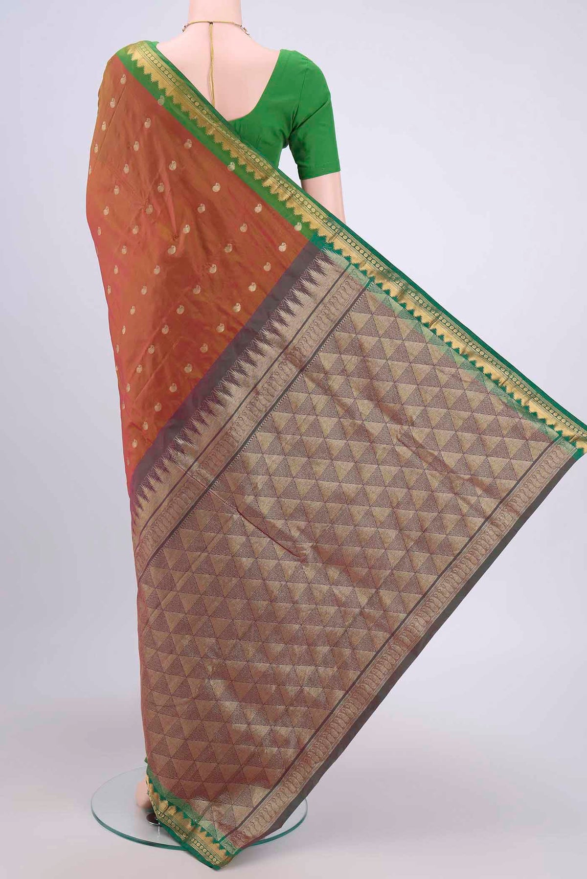 Flat view of Brick Orange Dual Tone Blended Bangalore Silk Saree with Zari Butta on the body and Temple Border. 