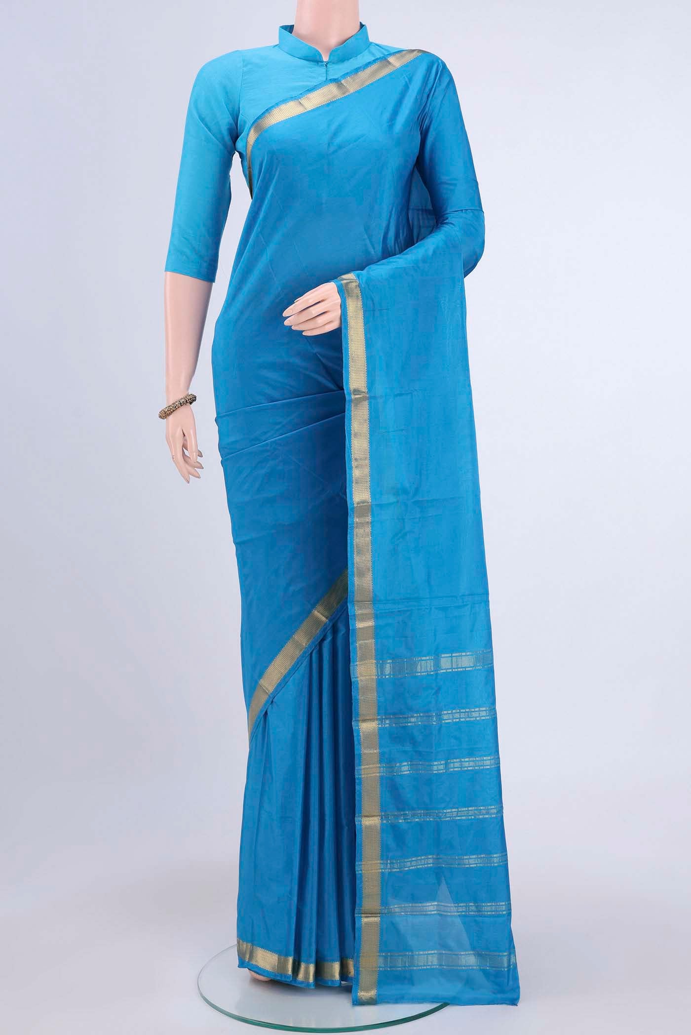 Blue Blended Bangalore Silk Saree with Plain Body and Zari Border displayed on a mannequin