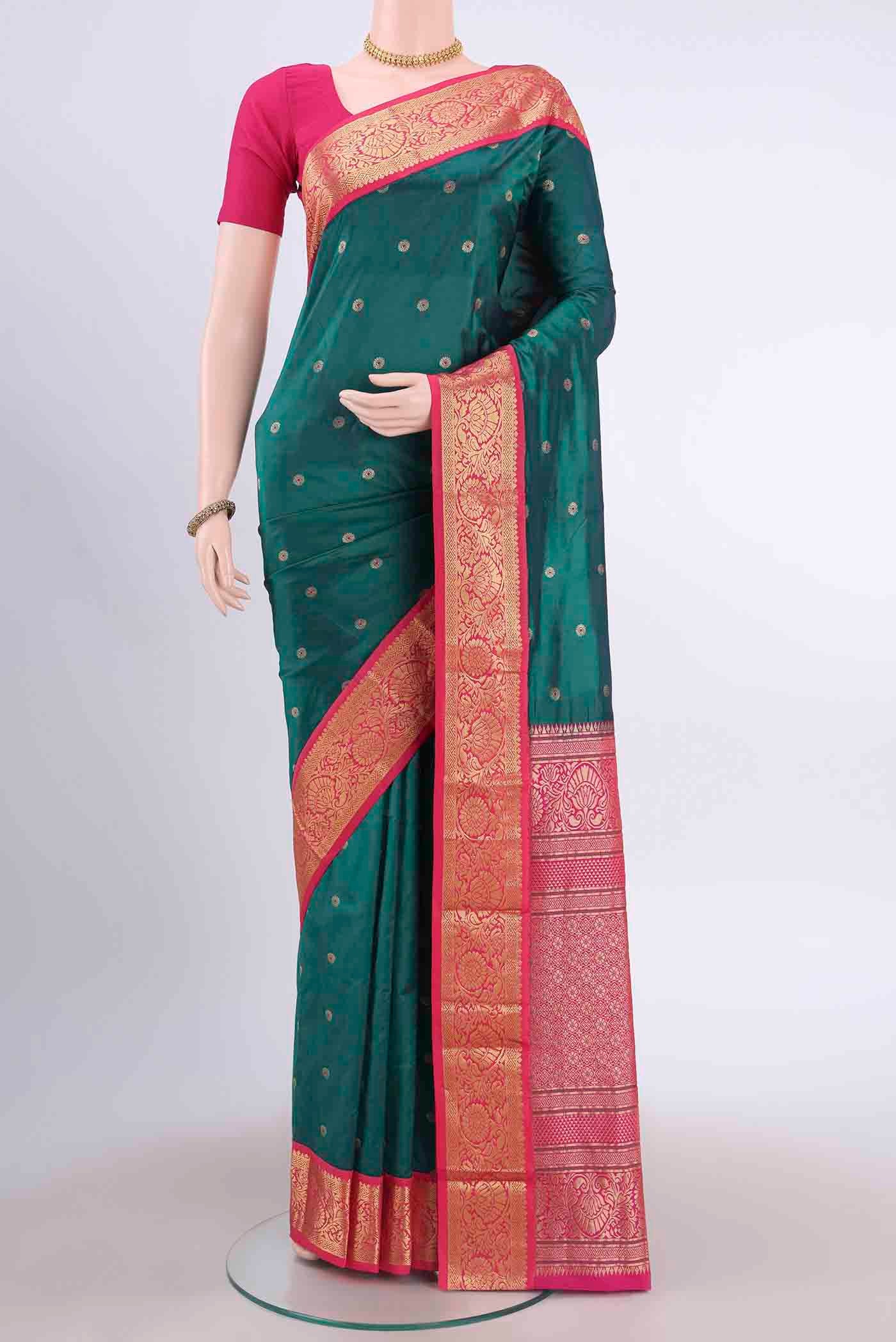 Bottle Green Blended Bangalore Silk Saree with Zari And Thread Butta on the body and Zari Border displayed on a mannequin