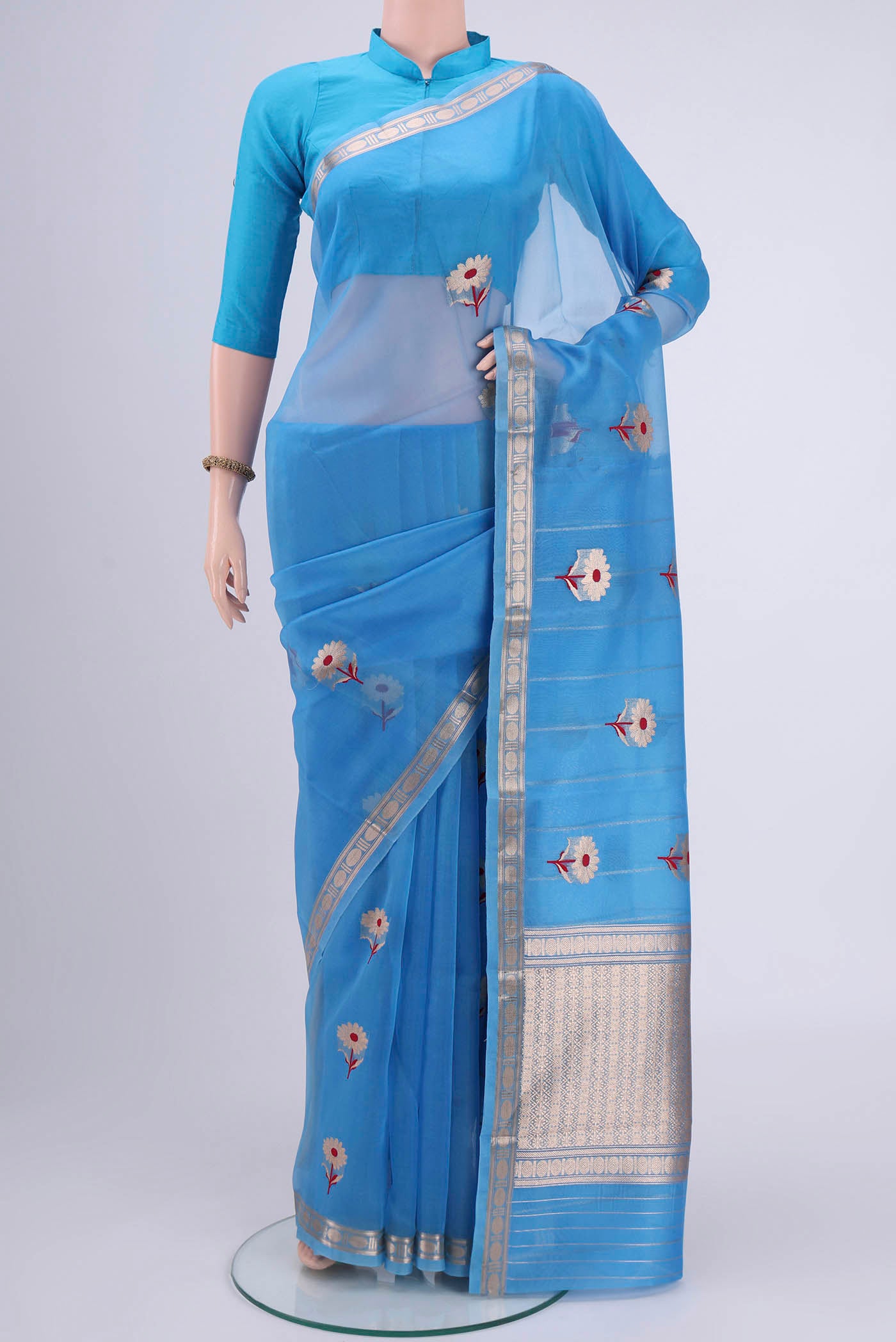 Blue Organza Silk Saree with Zari Butta on the body and Zari Border.  displayed on a mannequin
