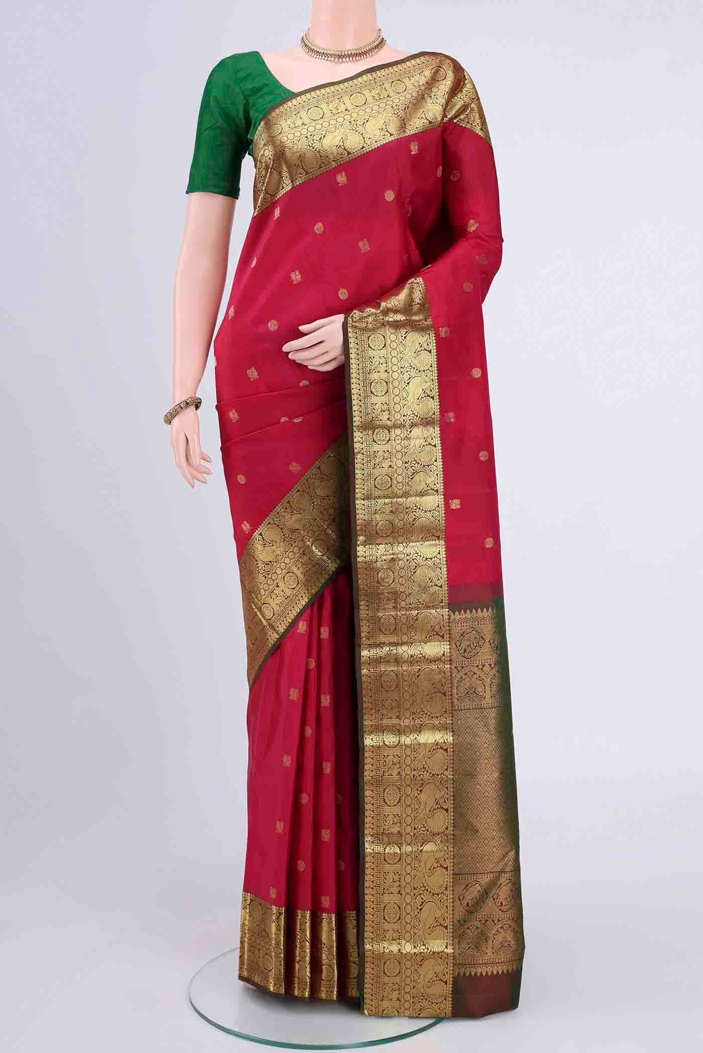 Dark Pink Kanchipuram Saree with Zari Butta on the body and Zari Border displayed on a mannequin