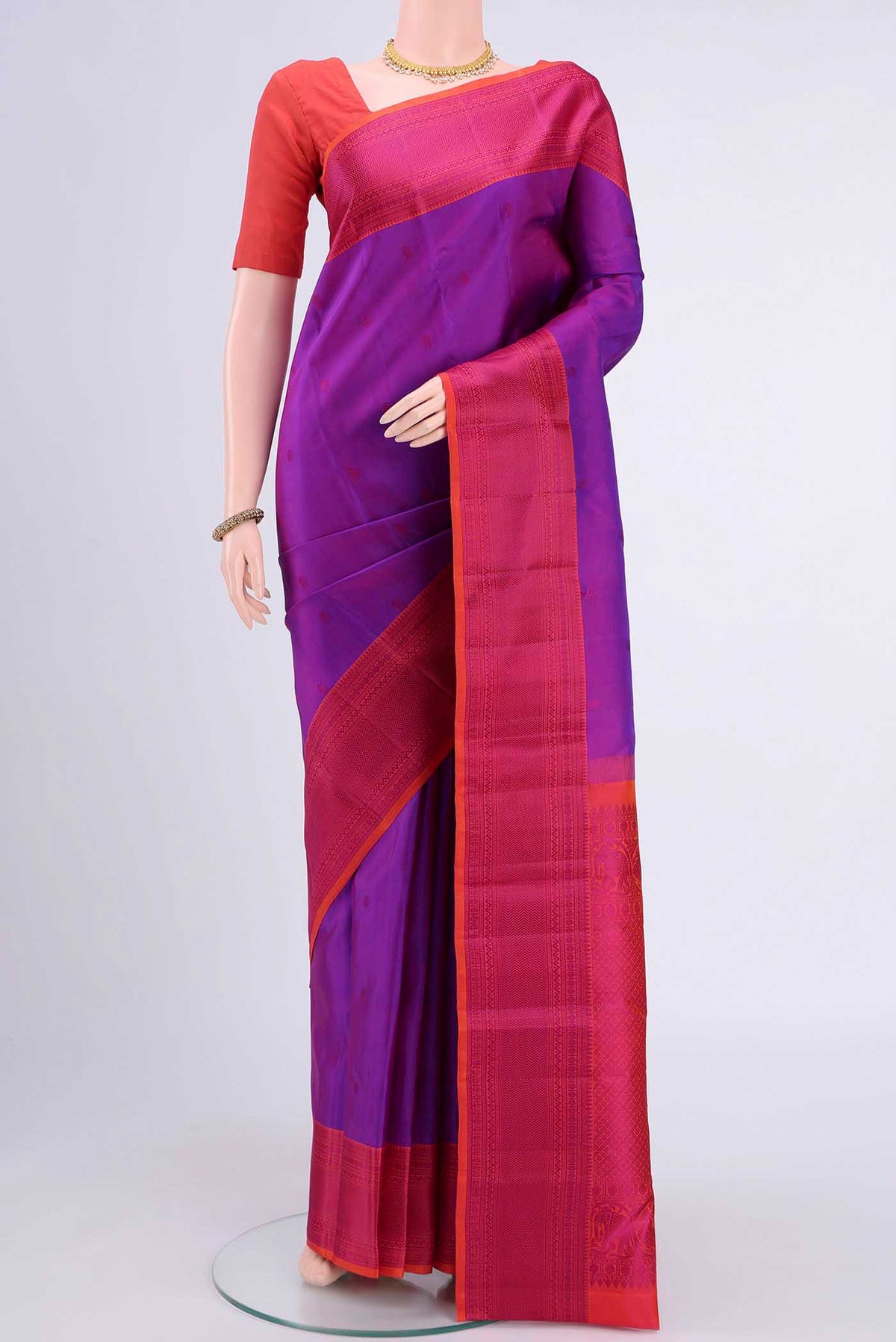 Magenta Kanchipuram Silk Saree with Thread Butta on the body and Thread Border displayed on a mannequin