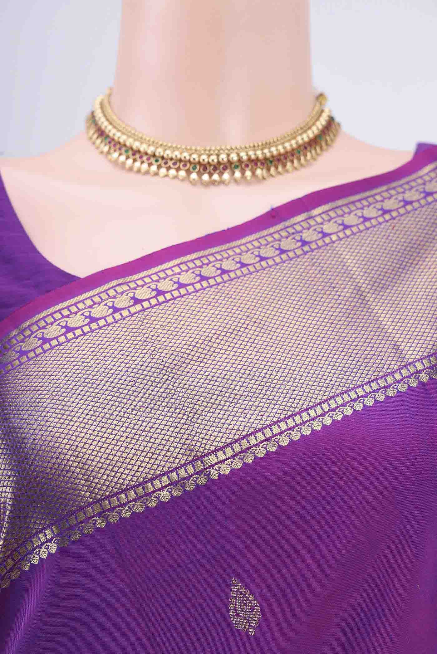 Border image of Magenta Kanchipuram Saree with Zari Butta on the body and Zari Border. 
