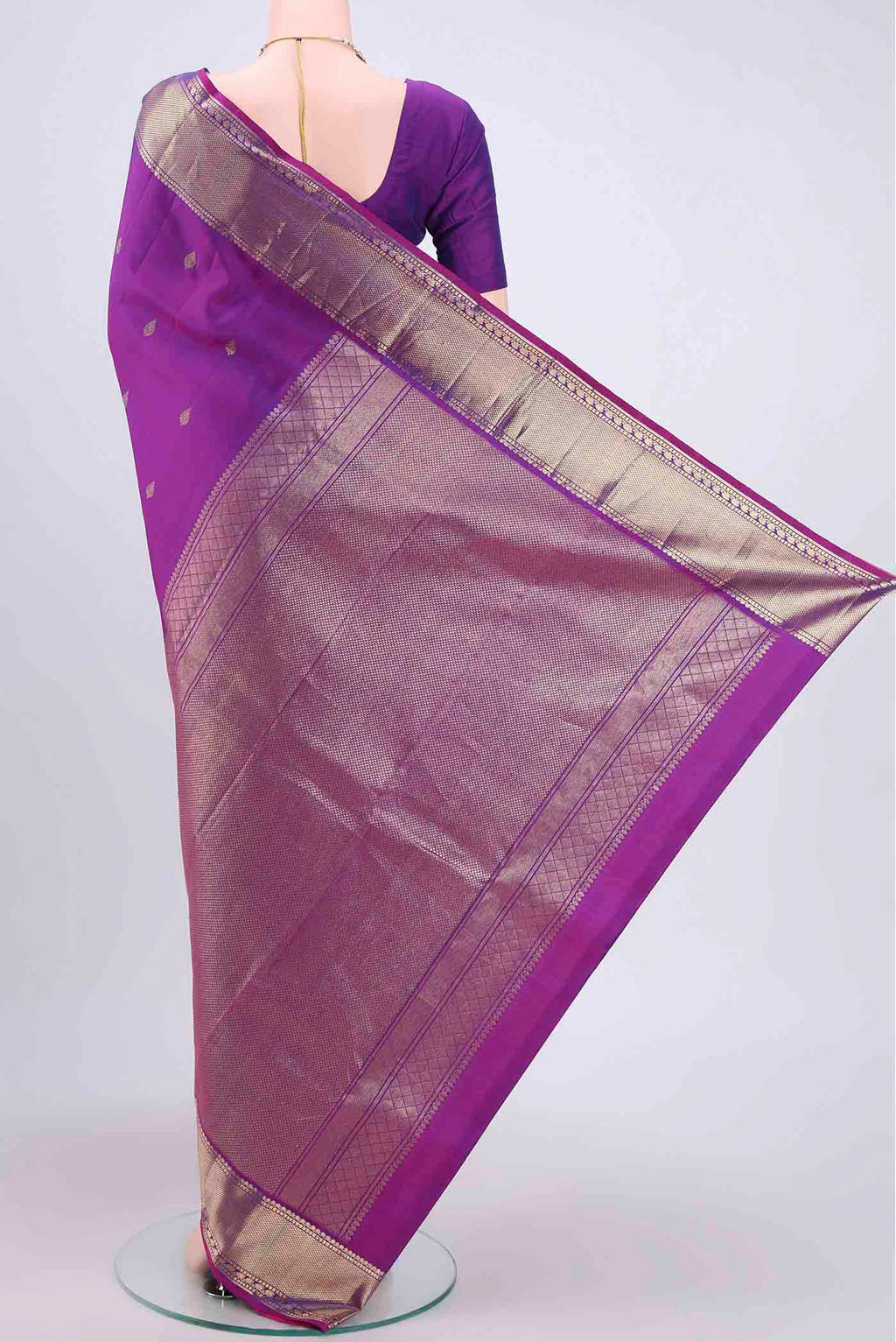 Flat view of Magenta Kanchipuram Saree with Zari Butta on the body and Zari Border. 