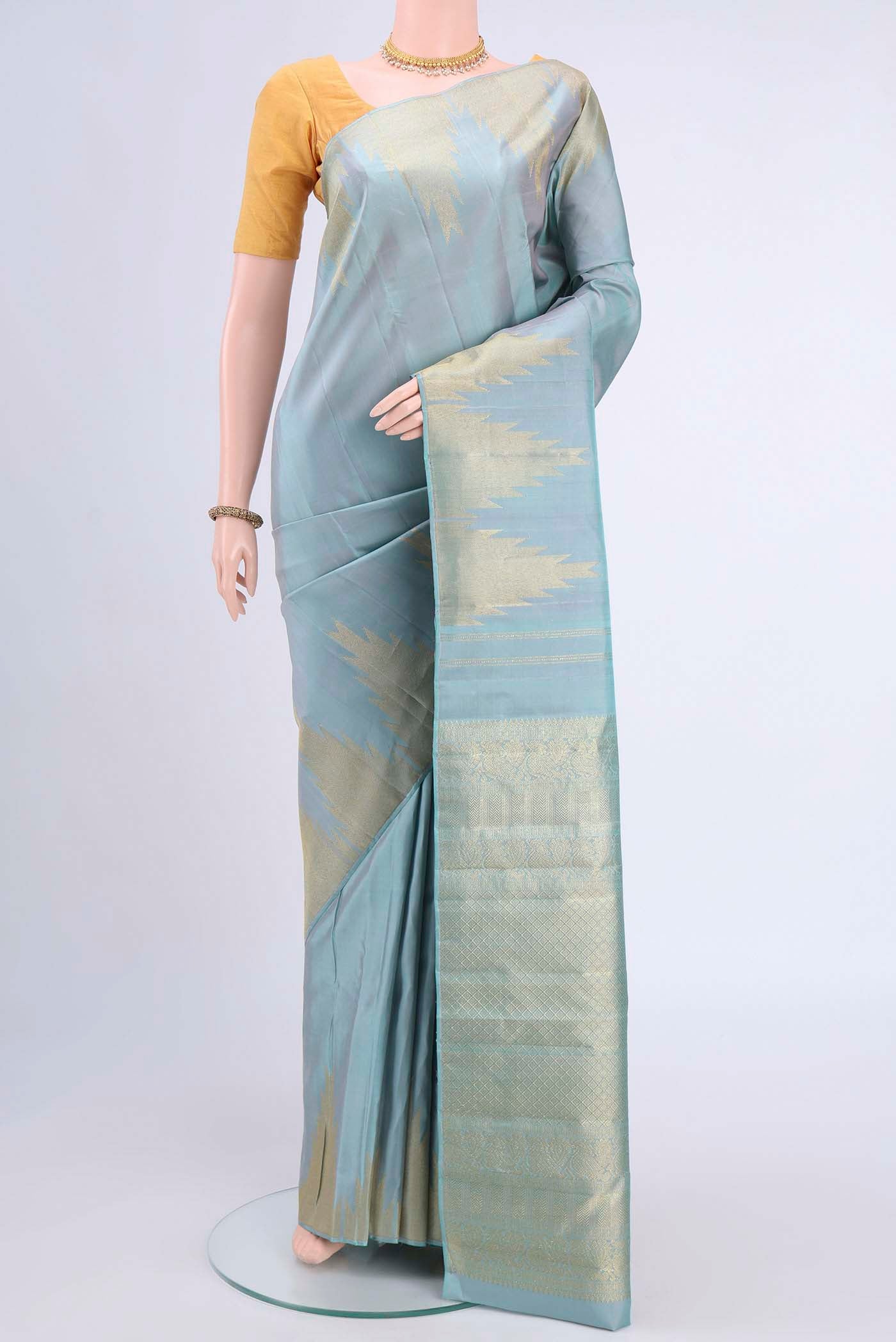 Sky Blue Kanchipuram Saree with Plain Body and Temple Border displayed on a mannequin