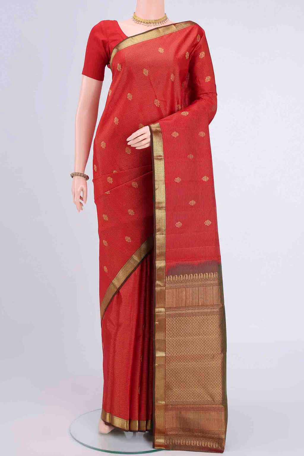 Imperial Red Kanchipuram Saree with Stripes on the body and Zari Border displayed on a mannequin