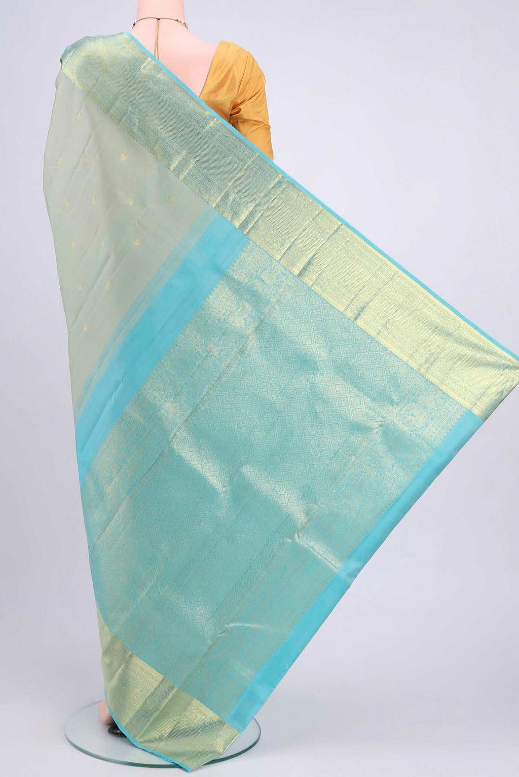 Flat view of Sage Green Kanchipuram Saree with Zari Butta on the body and Zari Border