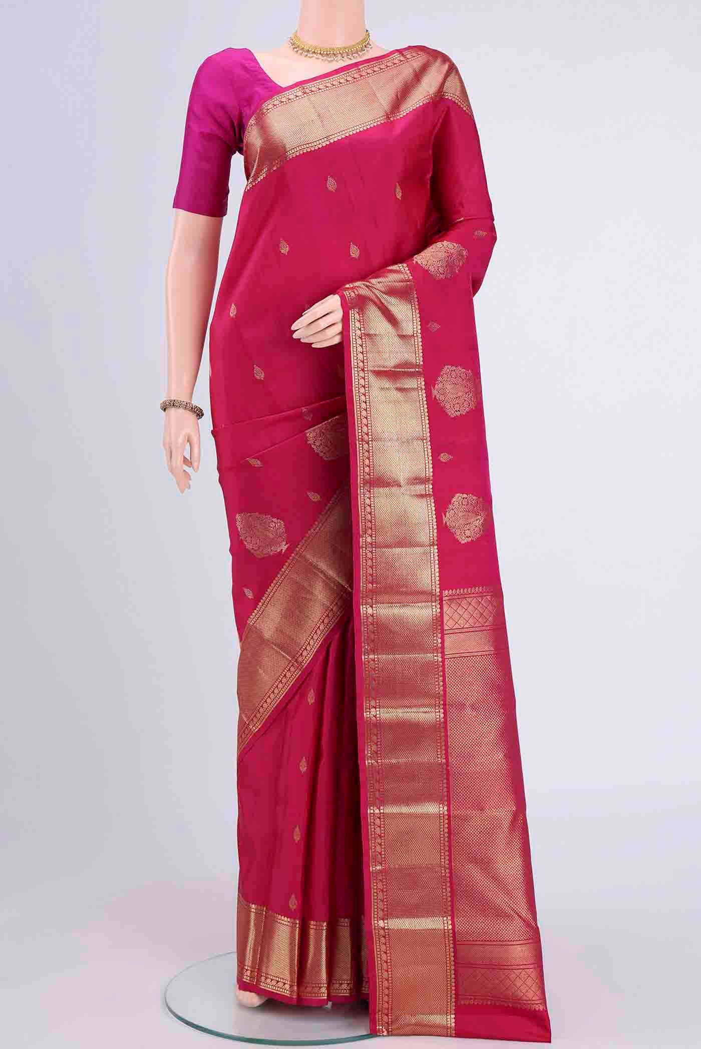 Dark Pink Kanchipuram Saree with Zari Butta on the body and Zari Border displayed on a mannequin