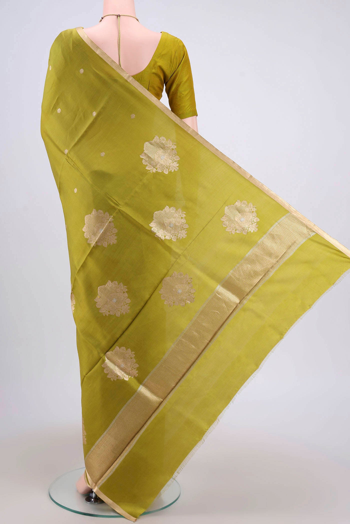 Flat view of Parrot Green Banarasi Katan Silk Saree with Zari Butta on the body and Zari Border. 