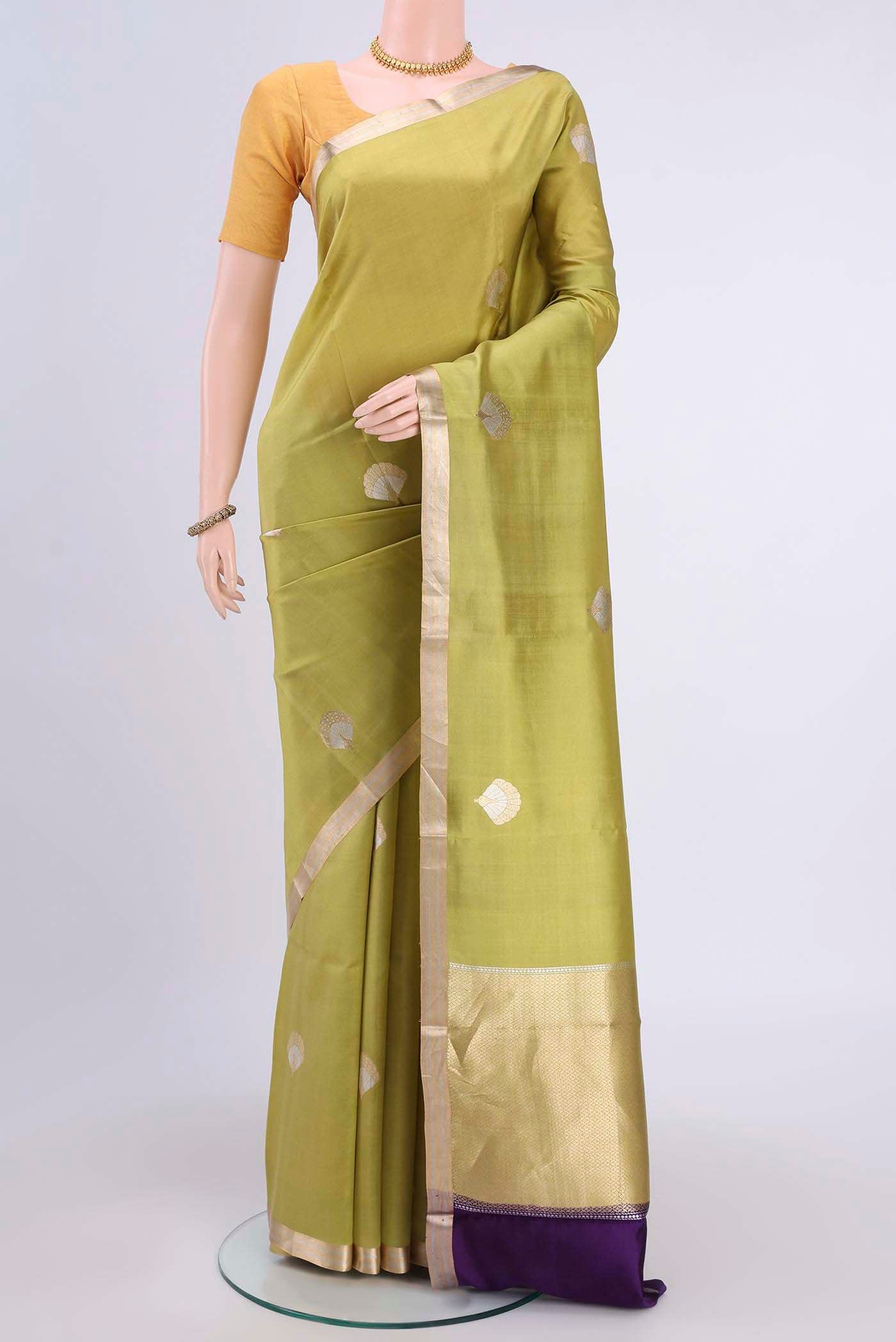 Light Green Banarasi Katan Silk Saree with Zari Butta on the body and Thin Zari Line displayed on a mannequin