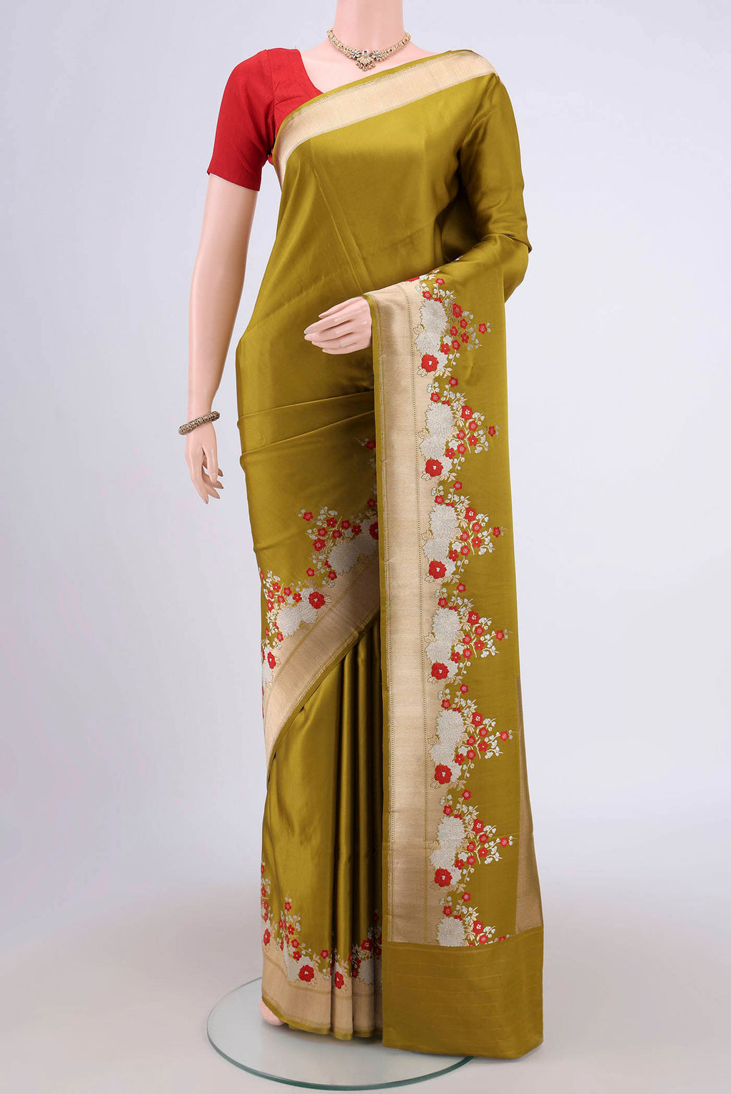 Mehandi Green Banarasi Silk Saree with Zari Butta on the body and Zari Border.  displayed on a mannequin