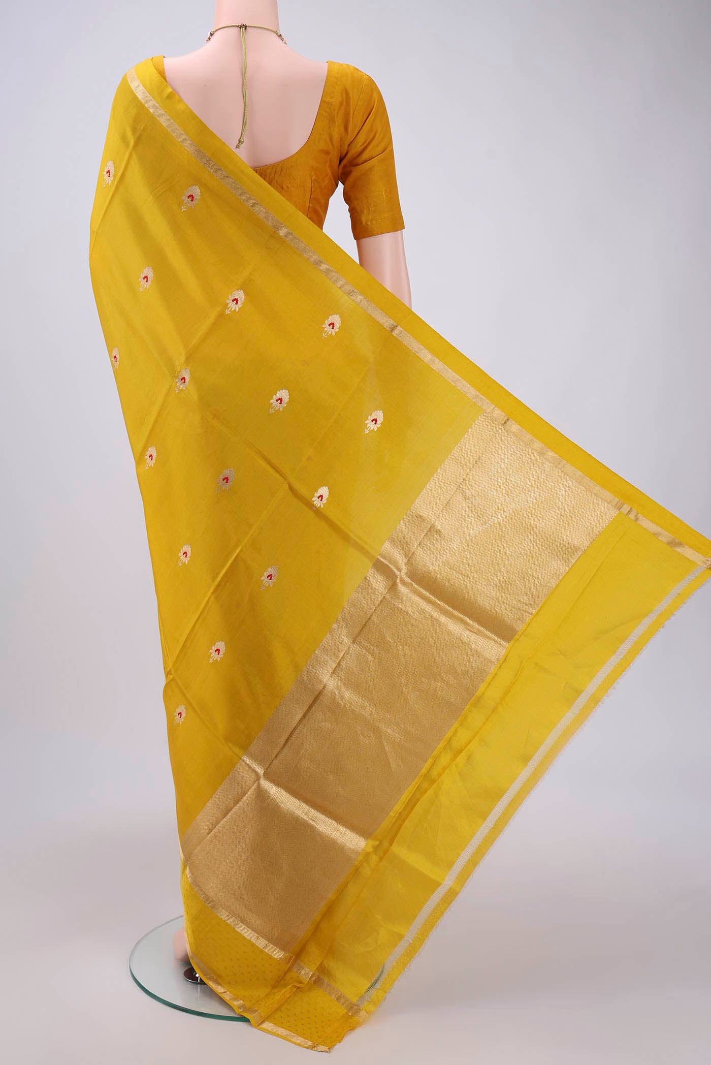 Flat view of Yellow Banarasi Saree with Zari Butta on the body and Zari Border. 
