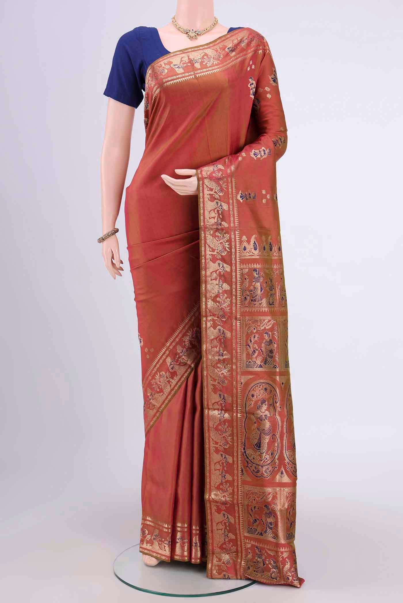 Rust Dual Tone Baluchari Silk Saree with Zari And Thread Butta on the body and Zari Border.  displayed on a mannequin