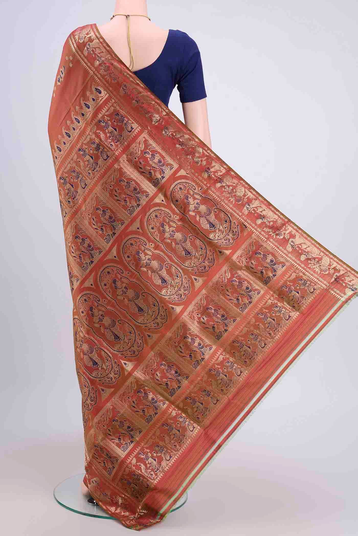Flat view of Rust Dual Tone Baluchari Silk Saree with Zari And Thread Butta on the body and Zari Border. 