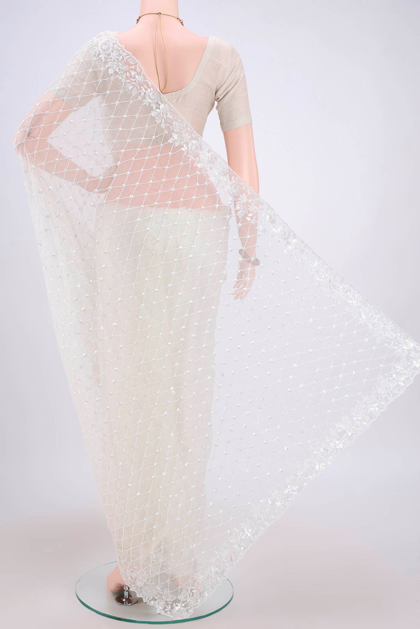 Flat view of White Organza Silk Saree with Embroidery on the body and Zari Border. 