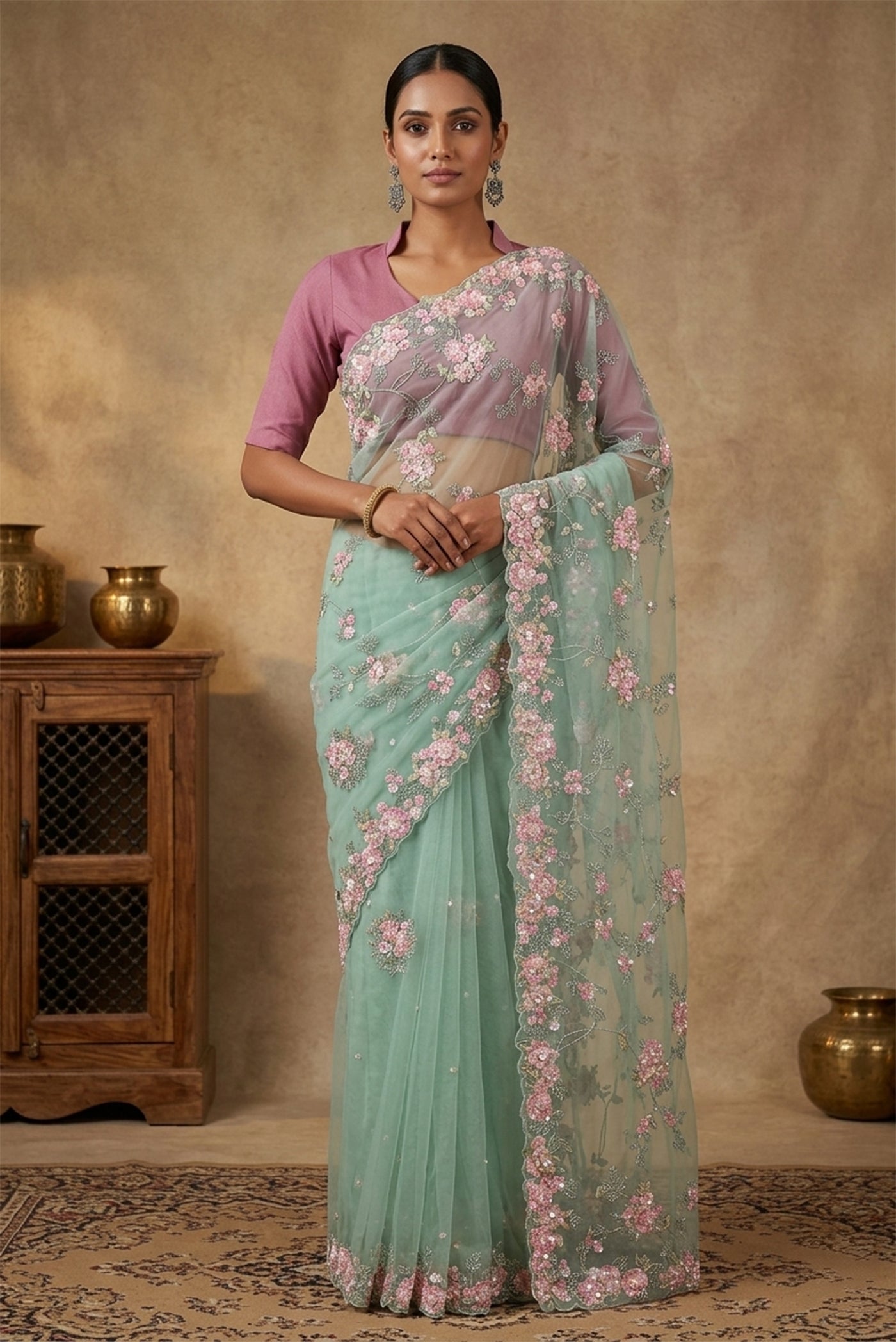 Model wearing a Mint Green Organza Silk Saree with Embroidery on the body and Embroidery Border.