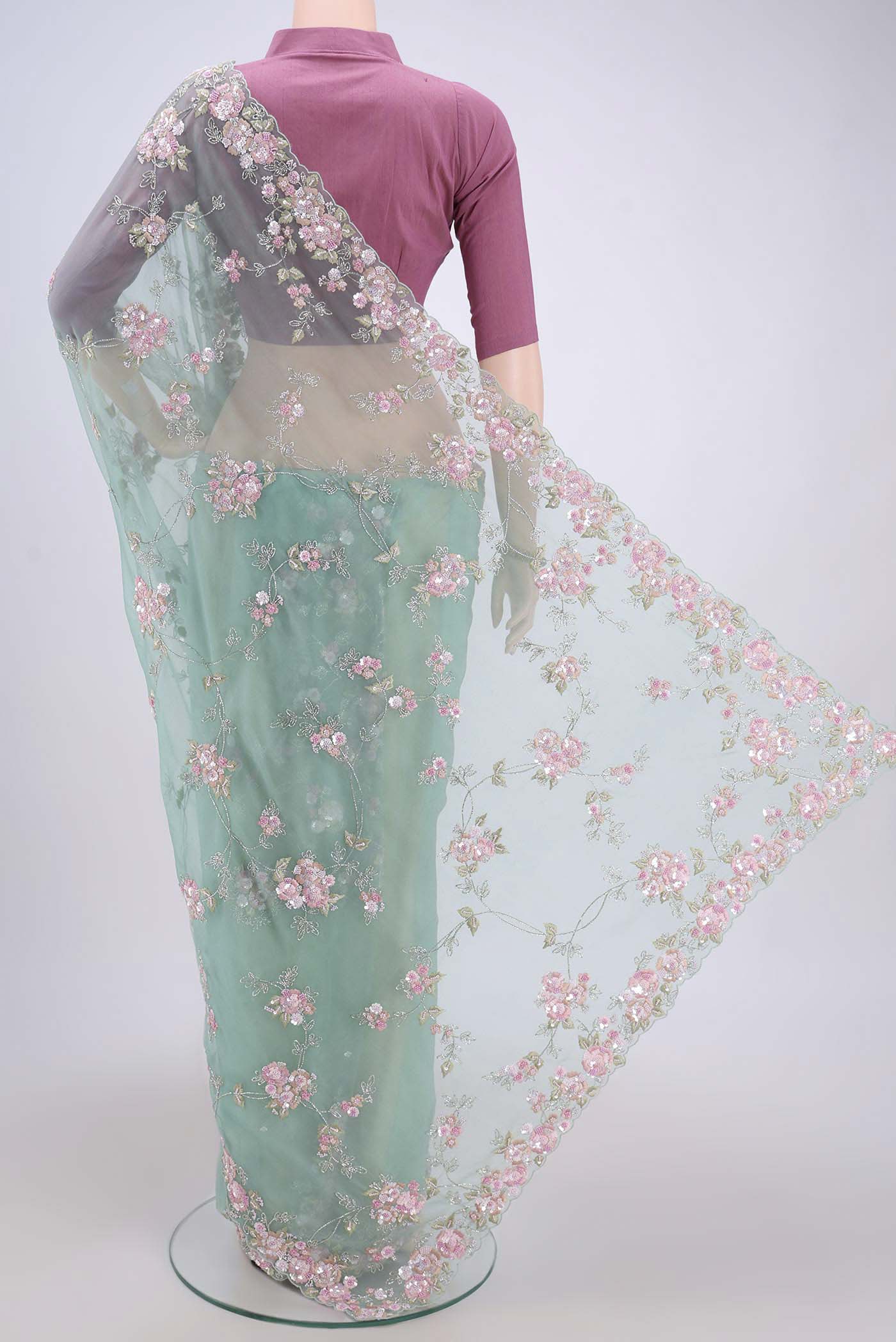 Flat view of Mint Green Organza Silk Saree with Embroidery on the body and Embroidery Border. 